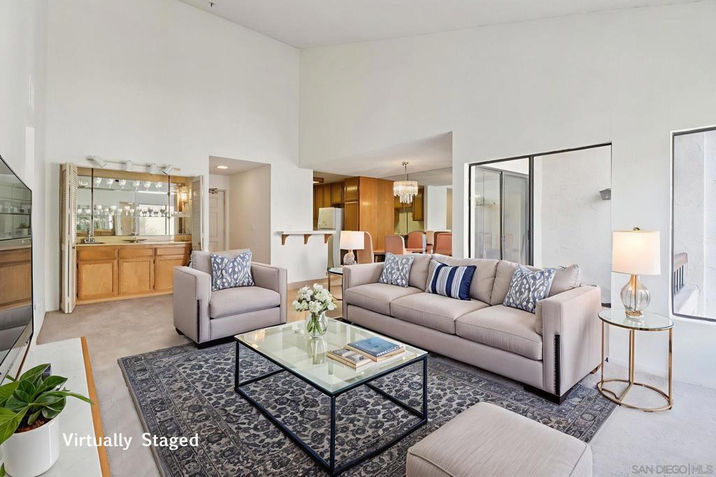 Opportunity knocks! This rare top-floor, corner unit 3-bedroom, 2-bath condo offers endless potential to make it your own at a great price. Light, bright, and airy, the spacious layout features an oversized living room with vaulted ceilings, a cozy fireplace, and wet bar, plus a dining area with balcony access. The kitchen provides abundant cabinetry and counter space, while the primary suite boasts dual closets, a covered balcony, and an ensuite bath with a large vanity, dressing area, and walk-in shower. Two additional guest bedrooms and a full bath provide flexibility for family, guests, or a home office. Additional highlights include in-unit laundry and ample closet space throughout. Set within a picturesque, guard-gated community with serene water features, residents enjoy resort-style amenities including a pool, spa, and tennis courts. Perfect for investors or owner-occupants alike, this home offers a prime West Mission Valley location close to Fashion Valley, YMCA, USD, the San Diego River Bikeway, and the exciting new Riverwalk project. With easy freeway access, you’ll be just minutes from beaches, Downtown, and all that San Diego has to offer!