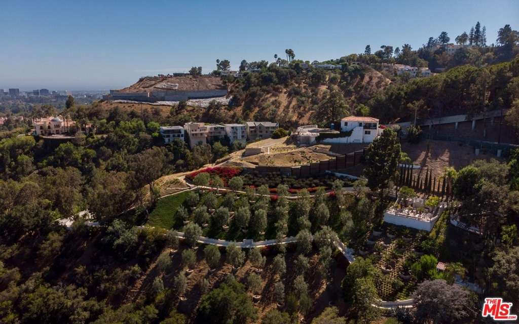 Approved plans for a 30,000+ sq. ft. modern Mediterranean home overlooking Beverly Hills. With plans designed to maximize light and views, the hillside architectural would fuse an entertainer's dream and a luxury retreat, from an expansive family and entertainment room to over 4,000 sq. ft. of covered patios, and even a wine tasting room with production capability and storage capacity for a world-class collection. Also outlined in the plans is a sumptuous private master suite with a private garden and pool. Revel in the beauty of the impeccable landscaping with olives, lemons, pomegranates, and avocados as well as legacy gardens. The dramatic motor court draws inspiration from the original Rudolph Valentino Estate. Formerly a retreat for the late socialite Doris Duke, the property also comes with an existing guest house and garage.