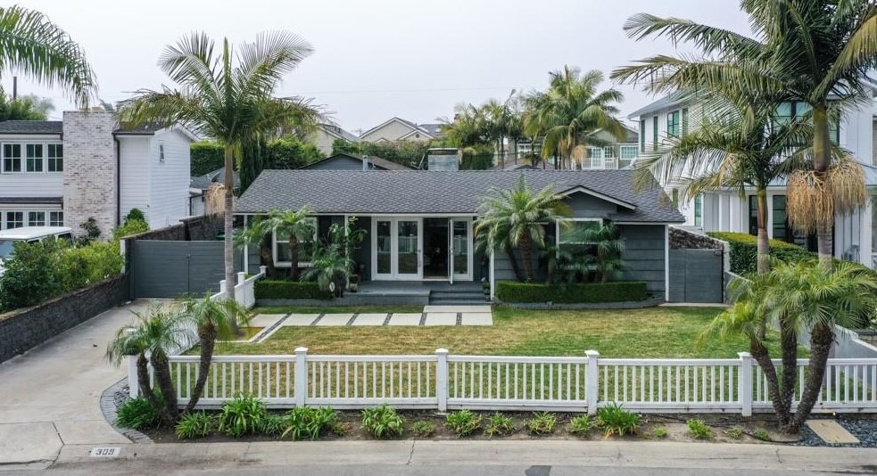 This is a short term lease for 3 months unfurnished. Nestled in the highly sought-after Cliff Haven neighborhood of Newport Beach, this beautiful single-story beach cottage seamlessly blends coastal charm with modern elegance. The home offers a spacious open-concept floor plan, inviting front yard with a lush lawn and a charming front porch with French doors, and a resort-style backyard designed for relaxation and entertainment. The private backyard features a saltwater pool and spa, a half bath for guests, an outdoor shower, and a stunning custom Redwood accent wall with barn doors, creating the perfect outdoor retreat. Inside, the home boasts a modern kitchen with stainless steel appliances, a farmhouse sink, and quartz countertops, while the dual-sided fireplace warms both the living and family rooms. The expansive detached garage, which can accommodate six cars or be transformed into a home office or gym, along with an extended driveway offering additional parking for an RV or boat, adds further appeal. Located just minutes from Newport Peninsula, Lido Marina Village, Balboa Island, and a variety of beaches, dining, and shopping destinations, this beach cottage provides an great opportunity to a short term lease in one of Newport Beach’s most desirable neighborhoods.