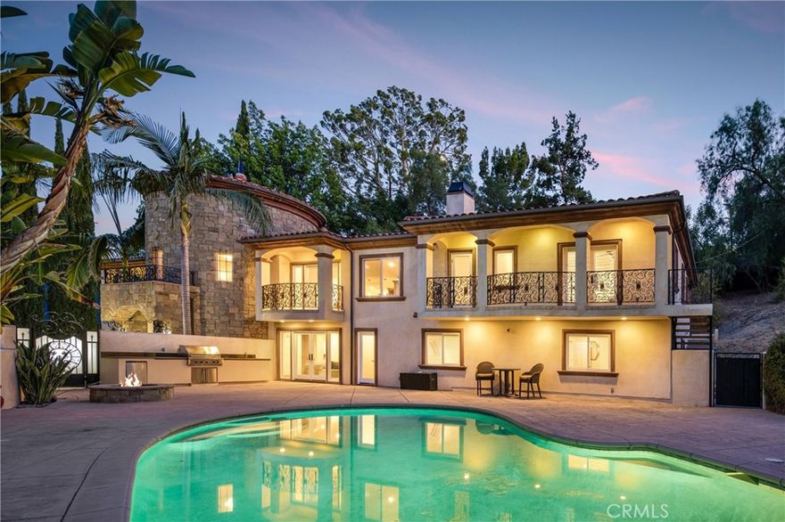 Behind private elegant gates, this breathtaking residence offers timeless elegance, privacy, and panoramic valley views. A grand 25-ft entry tower with Venetian plaster, dramatic banisters, and exquisite flooring sets the tone for the craftsmanship found throughout.



The gourmet chef’s kitchen features granite counters, custom cabinetry, Viking appliances, and a large center island with garden views—perfect for entertaining. Two main-level bedroom suites, a full bar, wine room/humidor, dumbwaiter, and laundry chute add convenience and luxury.



The primary retreat is a true sanctuary with Brazilian cherry wood floors, Carrera marble spa bath, fireplace, wet bar, balcony, and dual walk-in closets. Additional en suite bedrooms provide comfort and privacy for family and guests.



Resort-style outdoor living awaits with a sparkling pool & spa, Viking BBQ, fire pit, and expansive entertainer’s patio. A rare 6-car tandem garage ensures ample parking, while lush landscaping and long private driveway offer seclusion.



Built with no expense spared, this estate blends Old-World charm with modern amenities. Close to golf courses, hiking trails, Ventura Blvd dining, shops, and more. This home defines luxury living in prime Tarzana. AVAILABLE FOR RENT UNFURNISHED $15,900