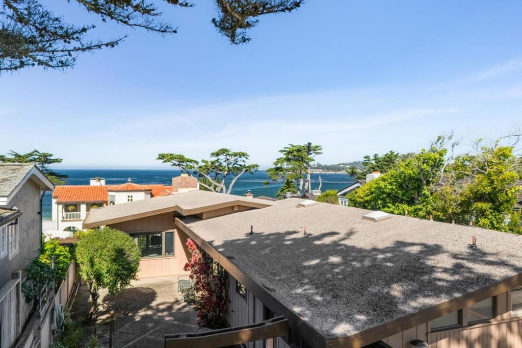 Welcome to "Surf's Up" the coastal retreat many have envisioned but few can achieve. Just steps away from the pristine white sands of Carmel Beach, this enchanting single-level home is on the market for the first time since being built in 1966. The views capture perfectly the essence of Carmel-by-the-Sea: Emerald blue water, white sand beach, and mature Monterey cypress trees. As you step inside, youll find high ceilings, a wall of windows and skylights, the fill the home with natural light. The open concept kitchen, dining and living room was ahead of its time and keeps all eyes towards the sea. The oak floors were just uncovered; having been protected for 5+decades by carpet. The home features four bedrooms, two with ensuite bathrooms. An additional two bedrooms and full bath are down the hall and have a door to the patio. Outside, the fenced and private yard has a nice south facing patio and screening. The lower yard also gives way to additional storage area that was used by the owners as an art studio. What a perfect place for your surfboards, bikes and toys for around town! The proximity to the beach means that the sounds of the ocean are never far away, making this the ideal location for beach lovers and dog walkers. "Surf's Up" is ready to be your coastal home.