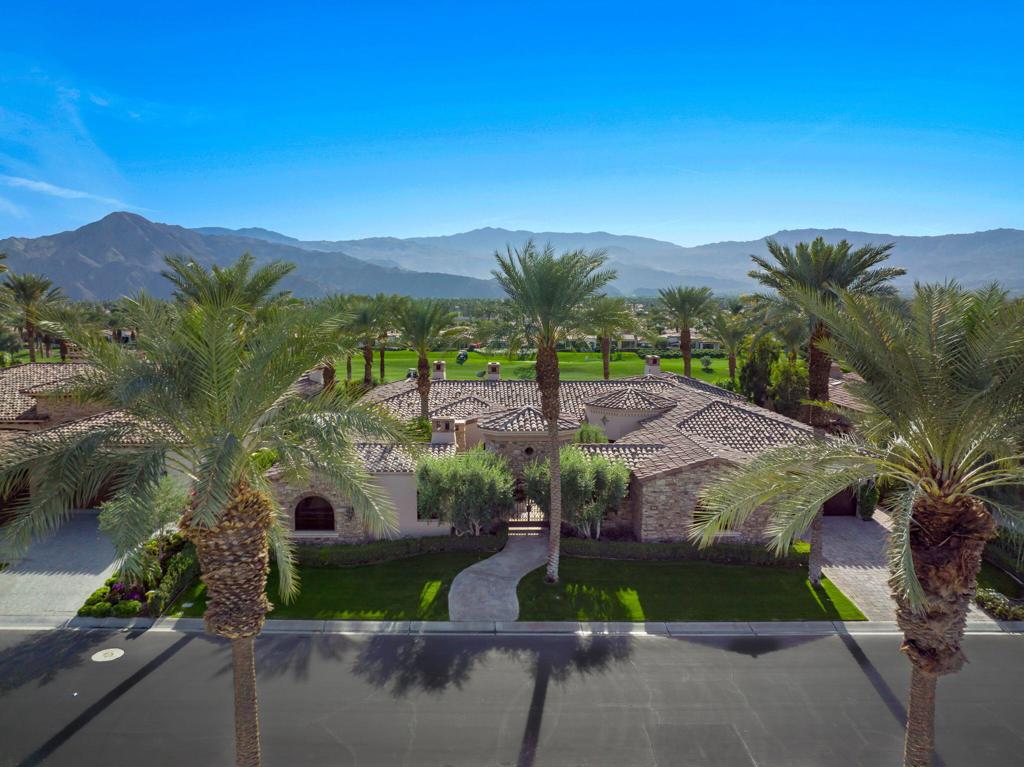 Indian Wells is home to this south facing custom estate located inside gated Toscana Country Club. Romantic features are prevalent in this contemporary custom villa from the moment you enter into the gated courtyard. Your eye will be immediately drawn to the jaw-dropping panoramic mountain views and double fairway while taking with it the large outdoor living/dining areas replete with pool, spa, fire pit and covered outdoor kitchen. The true display of genius lies in the graciously designed floor plan that allows true California desert living to unfold. Walls of glass open up to allow the exterior and interior living and dining spaces to live as one. The gourmet kitchen will be the place where you captivate your family and friends to experience culinary delights and perhaps the sous chef in the butlers kitchen as your back up. Store your wine collection in the temperature controlled wine room. The formal octagonal dining room is exquisite, or enjoy the view from your informal dining area large enough to seat the entire family and guests. The impressive master suite has double baths, double custom walk in closets, double shower, soaking tub & 2 water closets! Three other uncompromising suites for your guests offer the ultimate in luxury, including a quaint and private 2 room detached casita with a fireplace, bath and kitchenette! A cozy den, separate laundry room, 2 powder rooms and a huge exercise/office area complete this amazing home. It is simply Stunning!