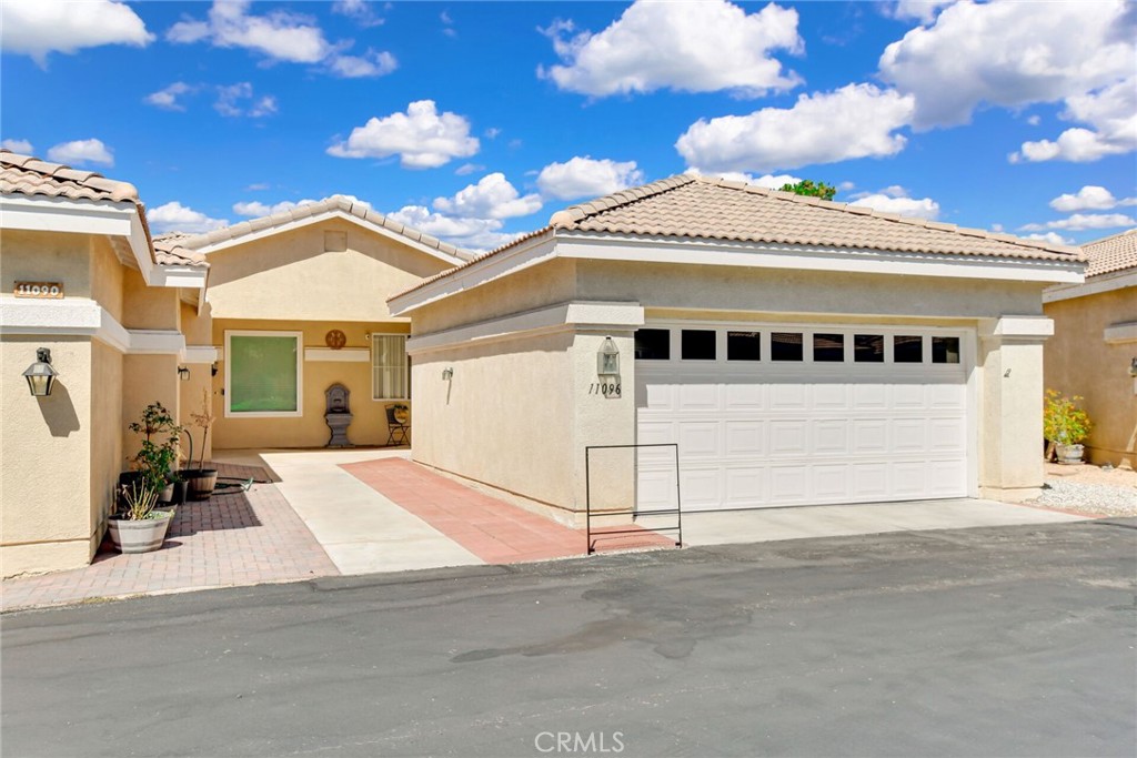 Welcome to this well-maintained 2-bedroom, 2-bathroom home in Sun City Del Webb, a 55+ gated community in Apple Valley. The home features high ceilings, energy-efficient dual-pane windows, and a durable tile roof. The open floor plan has a kitchen with a breakfast bar that flows into the main living area, offering functional space for daily living and entertaining. The primary suite includes a private bathroom with a separate tub and shower. Flooring includes herringbone-pattern tile and carpet throughout. Additional highlights include an indoor laundry room and a cul-de-sac location. The backyard backs to Ashwood Golf Course and provides views of the nearby pond. Community amenities include two clubhouses (Aspen and Mariposa), fitness centers, four swimming pools, group exercise classes, social clubs, a billiards room, a library, and more. Located close to golf, shopping, and dining options.