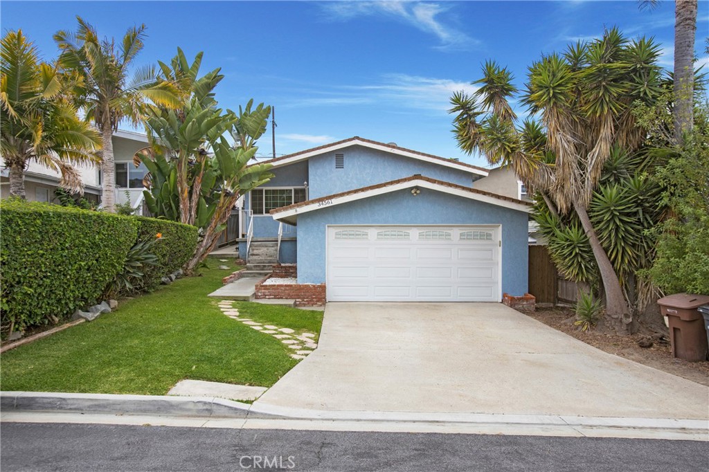 Live the coastal life in Capistrano Beach – Charm, comfort, and location! Enjoy the best of South Orange County living in this Capistrano Beach charmer, ideally located near Dana Point Harbor, Doheny State Beach, and the San Clemente Outlets. With beaches, dining, and recreation just minutes away, this home offers the lifestyle you've been waiting for. This split-level home features central air conditioning, a rare luxury in a coastal beach community, oak wood flooring, crown molding, Milgard double-pane noise-reduction windows, wood blinds, carpeting in the bedrooms, and an open floor plan. The updated kitchen features granite countertops, stainless steel appliances including a Whirlpool refrigerator and LG microwave, soft self-closing drawers, a corner cabinet lazy Susan, a spice carousel, a newer gas range, and a sleek stainless steel/glass range hood. Relax in the cozy living room by the fireplace or step outside to your private wood deck and backyard—ideal for morning coffee, evening wine, or simply catching coastal breezes. The primary suite offers direct backyard access and a private en-suite bathroom, while two additional bedrooms feature mirrored wardrobes and ample natural light. The hallway bath features a walk-in shower, a designer glass bowl sink, and linen storage. The attached two-car garage houses the washer and dryer, a newer water heater, and has a newer LiftMaster garage door opener and convenient keypad entry. Low tax rate, no HOA fees or Mello-Roos, close to freeway access for fast commuting and weekend getaways; this is a must see!