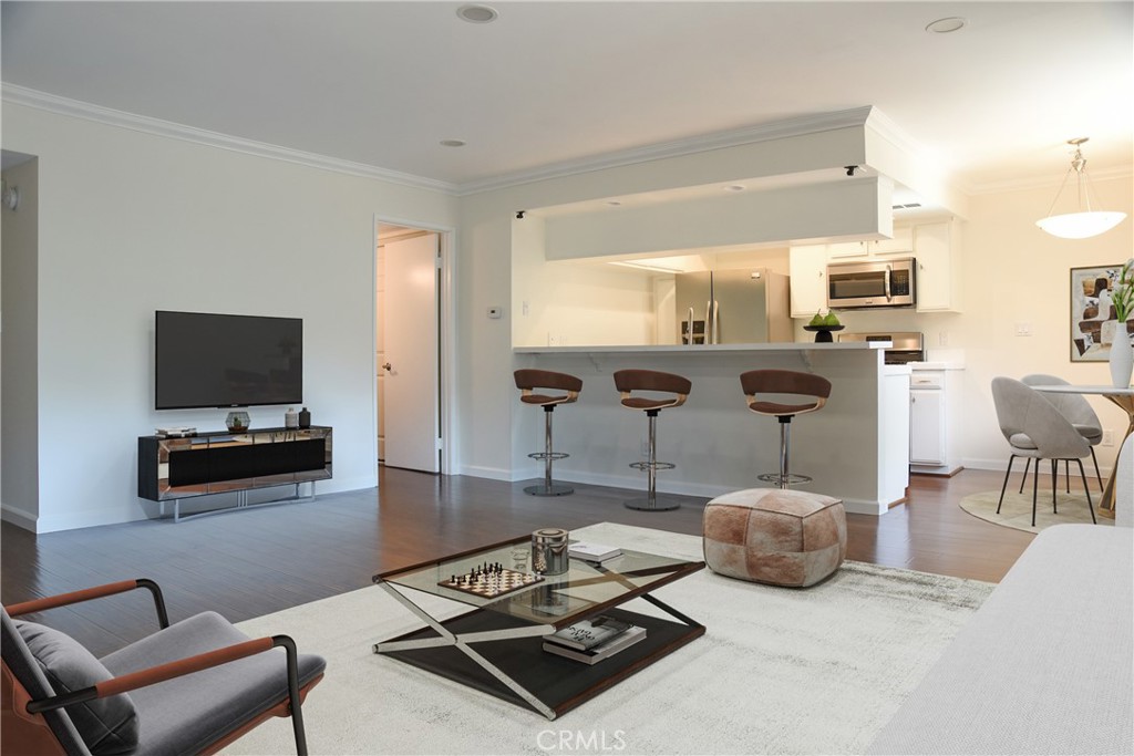 This perfectly situated 2 bedroom condo is in the Cahuenga Hills Tennis Condominium Complex close to Hollywood Bowl, shopping and entertainment. It is a gated community that ensures privacy and security with a tranquil environment, surrounded by mature trees. You will enjoy active living with the ample amenities available such as 3 tennis courts, 2 swimming pools, jacuzzi, an updated gym, 2 billiard tables and ping pong table in the community clubhouse. You can take the stairs or the elevator to go to the unit on the second floor. This unit features recessed lighting in the spacious living room, both bedrooms and the kitchen. The primary bedroom has a good size bathroom with a large bathtub with shower. There is a closet on the hallway inside the unit with washer/dryer hookups as well as a communal laundry outside on the same floor. The kitchen is equipped with a double sink, stainless steel appliances including refrigerator, 5-burner gas range, microwave and a new dishwasher. You have a beautiful view of the hills from the balcony and an assigned covered parking space with additional storage just below the unit. A full time on-site staff to assist with the residents' needs, maintenance and security.