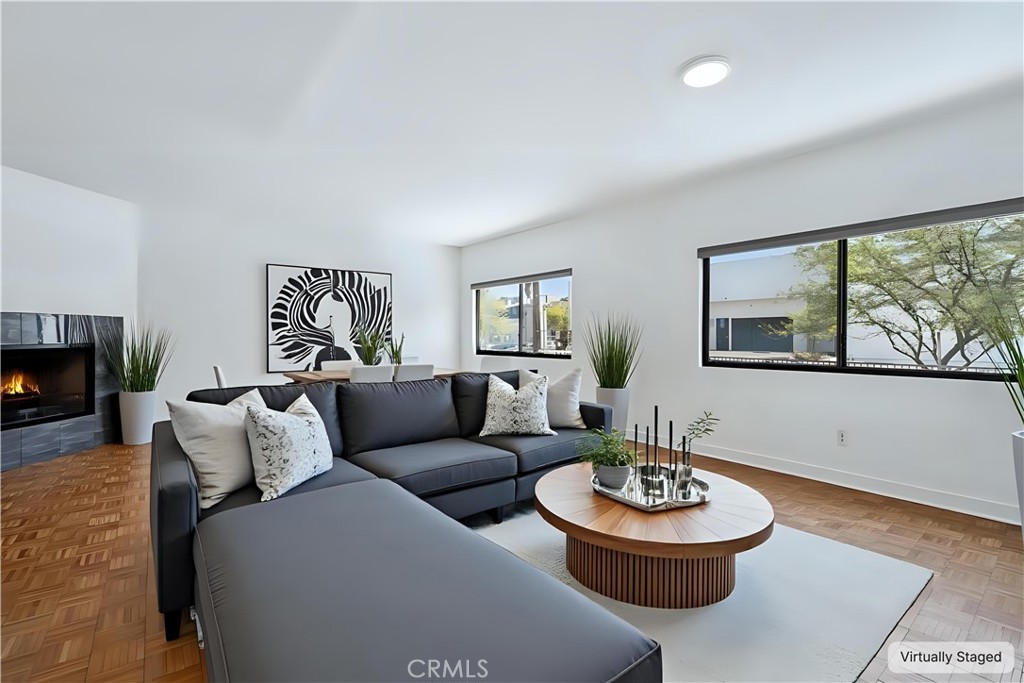 Amazing townhome located in the perfect spot - one block from Ventura Blvd in the heart of highly desirable Studio City. High ceilings with lots of light, hardwood floors, fireplace, stainless steel appliances, and laundry in unit. Corner unit in quiet back location of a small 8-unit building with only one common wall and double pained windows. Main bedroom is large and has a private balcony, walk-in closet, and vaulted ceilings. Spacious 2nd en-suite bedroom. The building features a beautiful swimming pool and a gated/secure garage with dedicated 2 parking spaces. This is beautiful oasis with all the best shopping, dining, entertainment and highly desirable schools right around the corner.