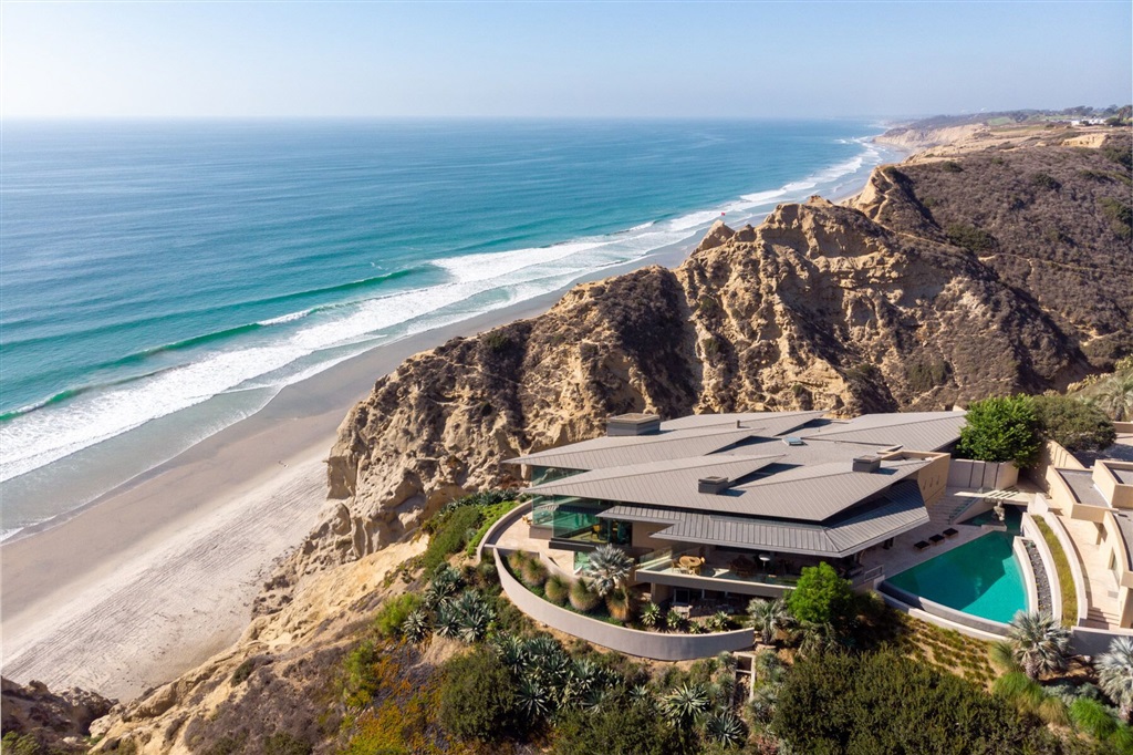 Bold and serene, this soft contemporary Ken Ronchetti designed home blends both warmth and elegant style seamlessly. Simply sublime and nestled between sandstone canyons, the idyllic oceanfront setting is exceedingly private. Through towering walls of glass with cinematic canyon, ocean and sandy beach views seen from everywhere, you can’t help but feel an indescribable sense of light and space. The Savant automation system adds comfort, control, and energy savings to this home allowing all technology to work together in one system. The entire homes’ thermostats, lights, audio, TV's, security cameras and door locks are all connected into a universal system, which is controlled from your smartphone and through iPads scattered throughout the house. In addition, and independent from the main home, are two separate dwellings; a 1BR guest house with views to the ocean, a zero-edge pool and rose garden. A detached studio/office with its’ own view terrace and full bath. This breathtaking home is positioned near Torrey Pines golf course, Del Mar race track, and La Jolla Playhouse. Additional details: 8627 sf of living space includes guest house and studio, 2932 SF of stone terraces, decks and balconies,1.19-acre site. Gated private driveway for ingress/egress, pool safety alarm, a 1071 SF. 3 car garage with storage, 1BR (700 SF) guest house with ocean views and separate washer/dryer. La Jolla Farms residency allows for private road beach access privileges. Please see attached schematic with all interior and exterior space measurements along with a Homeowner’s Technology Perspective. Property can be purchased fully furnished.. Neighborhoods: La Jolla Farms Equipment: Dryer,Garage Door Opener,Pool/Spa/Equipment, Range/Oven, Satellite Dish, Vacuum/Central, Washer, Water Filtration Other Fees: 0 Sewer: Sewer Connected, Public Sewer Guest House Est. SQFT: 697