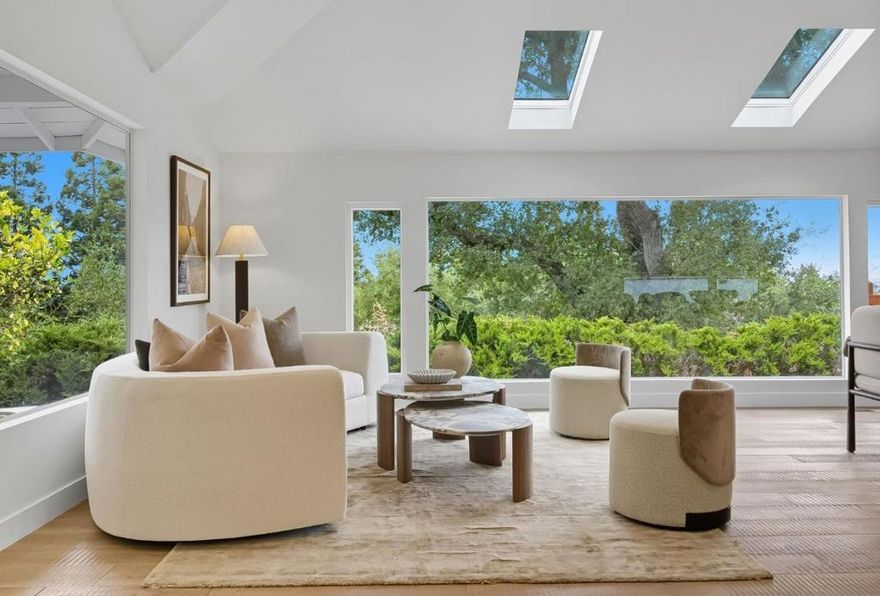 Perched on a private half-acre with sweeping views of Silicon Valley, this modern retreat blends city convenience with mountain serenity. The 3 bed, 2.5 bath home welcomes you with a light-filled open floor plan, soaring skylights, and warm engineered hardwood floors. A sleek modern kitchen with professional-grade appliances anchors the space, ideal for cooking and gathering. Recessed lighting, dual-pane windows, and an electric fireplace add to the elevated feel. A motorized gate provides privacy as you enter the property, leading to redesigned hardscape with concrete and pavers. The detached 2-car garage connects to the home with a breezeway, creating a seamless indoor-outdoor flow. Completely tucked away yet minutes from dining, shopping, and freeways, this is the rare home that feels like a getaway but lives like the city. Campbell Union schools: Alta Vista, Union Middle, and Leigh High. A must-see to truly appreciate the setting and style.
