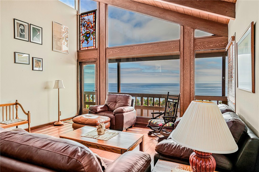 The Palisades neighborhood of San Pedro is a coastal community known to very few - offering spectacular ocean views and proximity to hidden beaches and stunning parks. This rarely available custom home on Silvius has almost 3200 SF of living space and boasts full ocean views from two levels as well as outdoor decks, patios and terraces that take advantage of outdoor space and the panoramic ocean views. Enjoy seeing Catalina Island and miles of the magnificent Pacific Ocean from this high vantage point both from the upstairs living room with its wood beamed vaulted ceilings and floor to ceiling windows that take advantage of the natural light, and the upstairs primary bedroom, also with high vaulted ceilings and full ocean views. Downstairs, the spacious family room and the well-appointed dining room face the ocean, both giving a delightful mid-century modern vibe with their wall built-ins and fireplace. The outdoor area has an amazing, expansive Trex deck, gas firepit, and multiple planters for you to enjoy indoor/outdoor living at its finest. The property has a total of 6 bedrooms, 4 bathrooms, fireplace, central heating, 2 car attached garage. Hardwood floors, recessed lighting, and custom window treatments are just a few of the other features this custom property has. This home is one-of-a-kind and is a soothing retreat to anyone who sets foot inside. Enjoy close access to White Point Park, Averill Park, Point Fermin Park, and the Korean Friendship Bell, while Palos Verdes is not much farther with all its trails and amenities such as golf courses and Terrenea Resort.