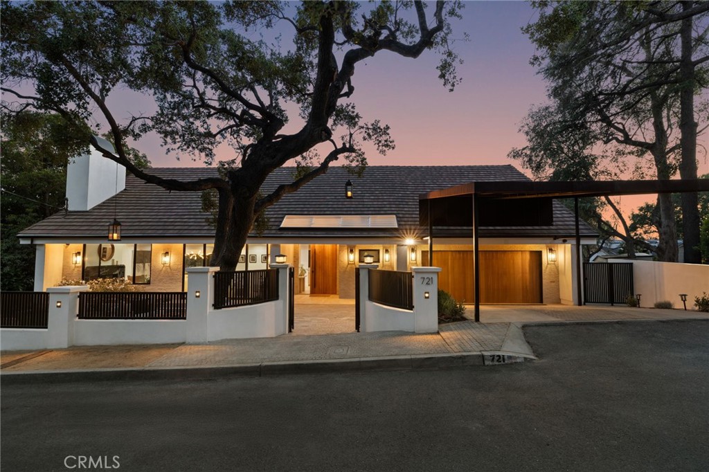 Nestled in the quiet upscale Burbank Hillside neighborhood, this exquisitely remodeled two-story view home is a seamless blend of transitional elegance and modern sophistication. With clean architectural lines, rich textures and thoughtfully curated finishes, this residence exudes warmth and timeless style. Upon entry through the 8 ft pivot front door you are welcomed by a light-filled floor plan featuring wide planked hardwood floors, soaring ceilings, and expansive windows that flood the space with natural light. The living room boasts a modern gas fireplace framed with a sleek quartz design and a custom built-in creating a tranquil yet refined focal point. The oversized glass sliders invite the beauty of nature inside.
The heart of the home is the stunning chef’s kitchen where form meets function. Features include high end custom flat panel white oak cabinetry with Brazilian quartzite countertops, state of the art appliances to include a sub-zero refrigerator, Wolf stove with pot filler and a premium Miele coffee machine. Beautiful glass cabinetry awaits your most coveted family heirlooms. The clever storage solutions ensure that the kitchen remains as practical as it is stunning. The kitchen flows effortlessly into the dining area creating an airy expansive atmosphere that is perfect for both entertaining and everyday living.
Retreat to the master suite which serves as a sanctuary, featuring a walk-in closet with built ins, soaring ceilings and alabaster pendant lighting. The luxurious master bathroom serves as a oasis equipped with a walk-in shower adorned with travertine tile and stand-alone tub, ensuring moments of solace and relaxation. There are two additional ensuite bedrooms that embody the essence of luxury with built in cabinetry, gorgeous bathroom tile, vanities and lighting.
Step outside to discover the gorgeous, oversized backyard with a built-in barbeque equipped with sink, refrigerator and bar area. There is a rustic stone fire pit perfect for summer evenings. Completing this remarkable property is a wellness room with four-person health mate sauna and gym area off of the two-car attached garage. This home offers convenient access to all freeways is close to upscale shopping, dining and the top-rated Burbank schools. Experience the perfect blend of luxury and lifestyle in this modern oasis where every moment feels like a retreat.