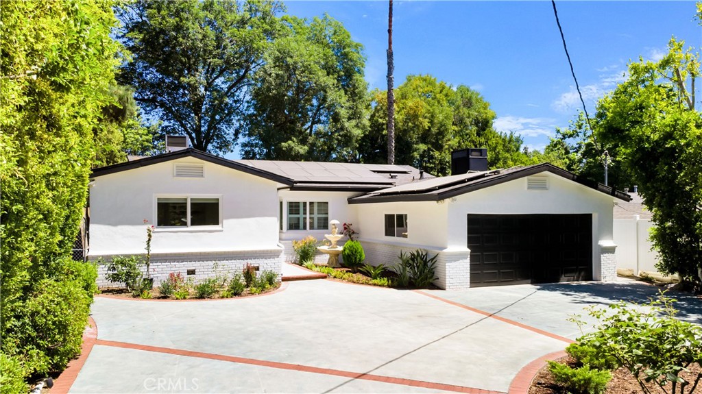 Remodeled mid-century ranch pool home situated on over 1/4 acre in Studio City's coveted Beeman Park neighborhood. The home sits high off the garden-like street with towering trees and beautiful grounds. Enter the extra large circle driveway that can accommodate numerous cars in addition to the two-car garage. Much of the home has been sound proofed and acoustically treated creating an incredibly quiet and peaceful environment indoors. Real hardwood walnut floors throughout the home give a sense of warmth while blending traditional design aspects with its recent modern upgrades. Bathrooms have been fully renovated with beautiful tile floors, fixtures and finishes. The brand new kitchen is the perfect culinary center for the at home chef with lots of natural light, clean quartz countertops, large floor tiles, Viking range, new dishwasher and refrigerator. Three bedrooms including an oversized primary, approx 600 sqft ensuite with walk-in closet, a stunning new luxury bathroom, featuring front-lit LED mirrors, a stand alone soaking tub and walk-in shower. Your very own resort-like retreat awaits out back with the skylit patio, outdoor shower, and expansive pool, yard and a detached studio perfect for a home office, playroom or gym. Finished temperature-controlled garage PLUS, that can be used a playroom, office, or extra room. Highlights include fully PAID OFF two-year-old solar panels, roof, tankless water heater. Located just moments to Beeman Park, the Studio City Library and incredible dining and shopping options along Ventura Blvd. Don’t miss the opportunity to call this spectacular property home.