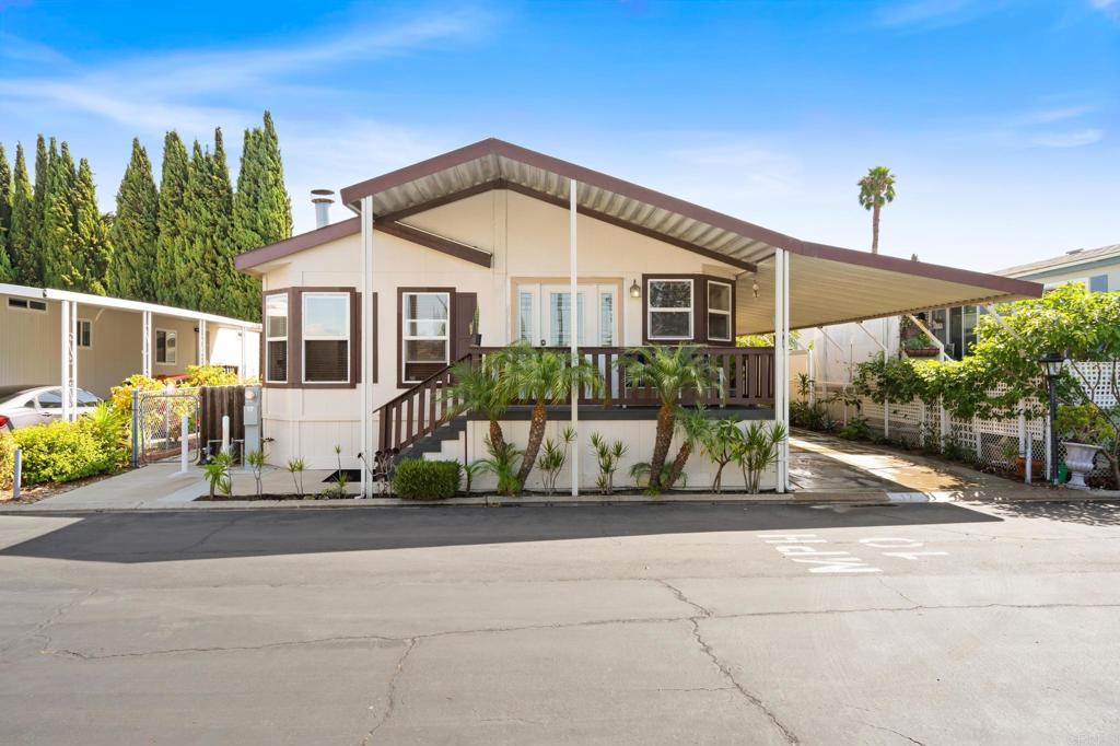 Wake up to natural light pouring through skylights, sip your morning coffee under vaulted ceilings, and enjoy the breeze you're just minutes from the beach. This spacious, sun-soaked manufactured home is tucked inside a quiet, gated, all-age community. Inside, you’ll find an open floor plan perfect for relaxing or entertaining, a cozy fireplace for cool evenings, ceiling fans throughout, and privacy hedges that create your own peaceful retreat. Right across from the clubhouse and pool, you're steps from connection or solitude, whenever you need it. There's room for 3 vehicles in your private carport, plus easy access to local shopping, major freeways, and the coastline. Coastal living without the coastal price. Convenience, community, and comfort all in one. Espanol: Despierta con la luz natural entrando por los tragaluces, toma tu café bajo techos altos y disfruta la brisa estás a solo minutos de la playa. Esta casa prefabricada amplia y luminosa se encuentra en una tranquila comunidad cerrada para todas las edades. En su interior, disfrutarás de un plano abierto ideal para relajarte o recibir visitas, una acogedora chimenea para las noches frescas, ventiladores de techo en todas las habitaciones y setos que brindan privacidad y tranquilidad. Ubicada justo frente a la casa club y la alberca, tendrás todo al alcance ya sea para socializar o disfrutar de tu espacio. Hay lugar para 3 vehículos en tu cochera privada, y estarás cerca de tiendas, autopistas y, por supuesto, la costa.
