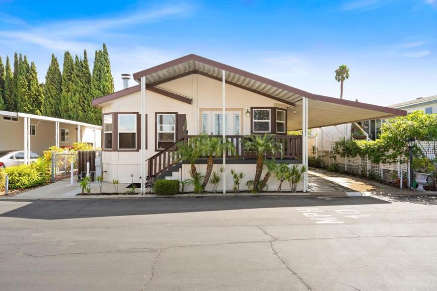 Wake up to natural light pouring through skylights, sip your morning coffee under vaulted ceilings, and enjoy the breeze you're just minutes from the beach. This spacious, sun-soaked manufactured home is tucked inside a quiet, gated, all-age community. Inside, you’ll find an open floor plan perfect for relaxing or entertaining, a cozy fireplace for cool evenings, ceiling fans throughout, and privacy hedges that create your own peaceful retreat. Right across from the clubhouse and pool, you're steps from connection or solitude, whenever you need it. There's room for 3 vehicles in your private carport, plus easy access to local shopping, major freeways, and the coastline. Coastal living without the coastal price. Convenience, community, and comfort all in one.  Espanol:  Despierta con la luz natural entrando por los tragaluces, toma tu café bajo techos altos y disfruta la brisa estás a solo minutos de la playa. Esta casa prefabricada amplia y luminosa se encuentra en una tranquila comunidad cerrada para todas las edades. En su interior, disfrutarás de un plano abierto ideal para relajarte o recibir visitas, una acogedora chimenea para las noches frescas, ventiladores de techo en todas las habitaciones y setos que brindan privacidad y tranquilidad. Ubicada justo frente a la casa club y la alberca, tendrás todo al alcance ya sea para socializar o disfrutar de tu espacio. Hay lugar para 3 vehículos en tu cochera privada, y estarás cerca de tiendas, autopistas y, por supuesto, la costa.