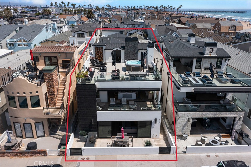 OCEAN VIEWS FROM ALL 3 FLOORS! Located just steps from the sand on one of the peninsula’s most desirable double wide streets, this extremely rare 35 foot wide lot was masterfully designed to incorporate two units with no shared vertical walls. The spacious upper unit consists of the full 2nd and 3rd floors, offering 2,467 square feet of living space, five bedrooms, 4 full bathrooms and multiple patio spaces. Upon entering the home, you will be greeted by 10 ft. ceilings, a white brick open fireplace in the living room and fully pocketing Fleetwood sliding glass doors for an effortless transition between the great room and a 320 sq. ft. patio with firepit, BBQ and white water ocean views. Utilize the convenience of an elevator to access each floor, which includes a third-floor patio that consists of 300 sq. ft. of covered space with fireplace and 800 sq. ft. of uncovered patio space with firepit, 8 person jacuzzi hot tub and panoramic ocean and Catalina views. Enjoy the elegance and style of white oak flooring, custom oak cabinets and designer-appointed lighting, plumbing fixtures, tile and countertops throughout the home. The gourmet kitchen offers ample storage space and is fully equipped with a Sub-Zero/Wolf appliances including: fridge, freezer and wine fridge columns, oven, microwave and a separate Scotsman ice maker. An integrated Control4 audio visual system centrally controls separately zoned speakers and TVs throughout both the inside and outside of the home, ensuring seamless entertainment for you and your guests. The large primary suite features a fireplace, a spacious bathroom and a walk-in closet. Avoid the hassle of the typical condo tandem parking with a side-by-side two car garage dedicated to the upper unit. The lower unit offers the rare opportunity to have a handicap accessible 1,410 sq. ft., 3 bedrooms, and 3 bathrooms all on the ground floor. This unit provides a spacious great room with a Fleetwood sliding glass door that opens to a 300 sq. ft. patio with BBQ and ocean views. Parking for this unit includes a one car garage and covered carport. It has been used as a full-time rental (with short term permit), booked nearly year-round with countless 5 star reviews, and generates around $170,000+ per year. Whether you are looking for your own personal dream home, looking to maximize revenue, or something in between, this property offers the flexibility to tailor its use to suit your ideal scenario.