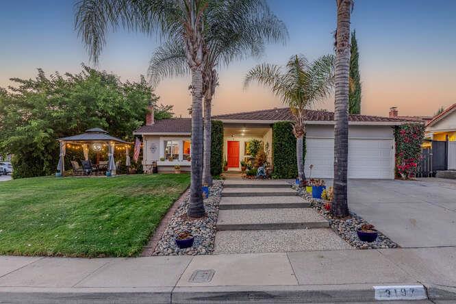 Welcome to the neighborhood! You will LOVE this home that has been cared for and adored by one owner for 3 decades. The corner lot is landscaped for beauty and function with shady trees, lush grass, and towering palms. Outdoor rooms will dazzle you day or night. A private patio is hidden by curtains ready for fun with TV, disco lights, string lights depending on your mood. Low care backyard is finished with hardscape, drought resistant plants, deck and firepit. Inside, you will love the flooring, and lighting in an amazing 1 story floor plan. The 4th bedroom is configured as an office with french doors. Stainless steel appliances, updated cabinets, counters and fixtures show off the classy kitchen. Matching features found in the baths 3 bedrooms have newer carpet and closet organizers! Spend the cool evenings at the gas fireplace and on hot days enjoy the NEW A/C! Primary bedroom has an electric fireplace that is as wide as your TV! It can provide heat or just light from a handy remote. There is a roomy carport with room for a work-space, parking, storage, or use it for a dog run. Covered for shade, there is power and lighting installed for you! Evergreen amenities await! See you at home!