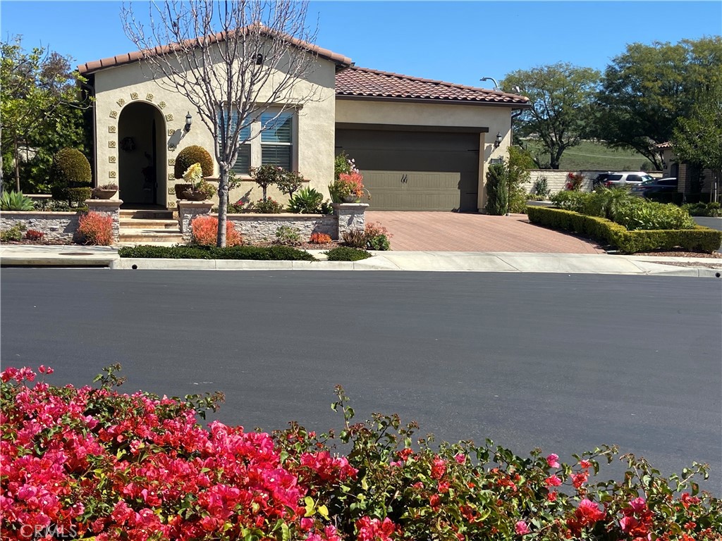 Welcome home to this single story corner lot home in the gated 55+ community of Buena Vida enclave at La Floresta. From the exterior of this home, with its great curb appeal to the amazing interior, this home offers an open and spacious floor plan with a lot of natural light and top of the line amenities. This home boasts a spacious kitchen with stainless steel appliances, a walk-in pantry, and a large granite kitchen island for entertaining. Its large dining area and family room overlooks the inviting and serene backyard with a stacked stone water fall and a covered patio for outdoor dining. Additionally, this home has a large primary bedroom and the primary bathroom has a large linen closet and walk-in closet for plenty of storage. Each window in the home has custom planation shutters and recessed lighting is found throughout the home. The inside laundry room has its own sink and sits just beyond the mud room. This home also has a spacious den/living room/office space/3rd bedroom option. Living in this community, you gain access to an exclusive clubhouse for residents and amenities such as a fitness center, lunge, ballroom, catering kitchen and multi-purpose room. Outdoor amenities include a pool and spa, sports courts and resident garden. This home is also closely situated to shopping and dining.