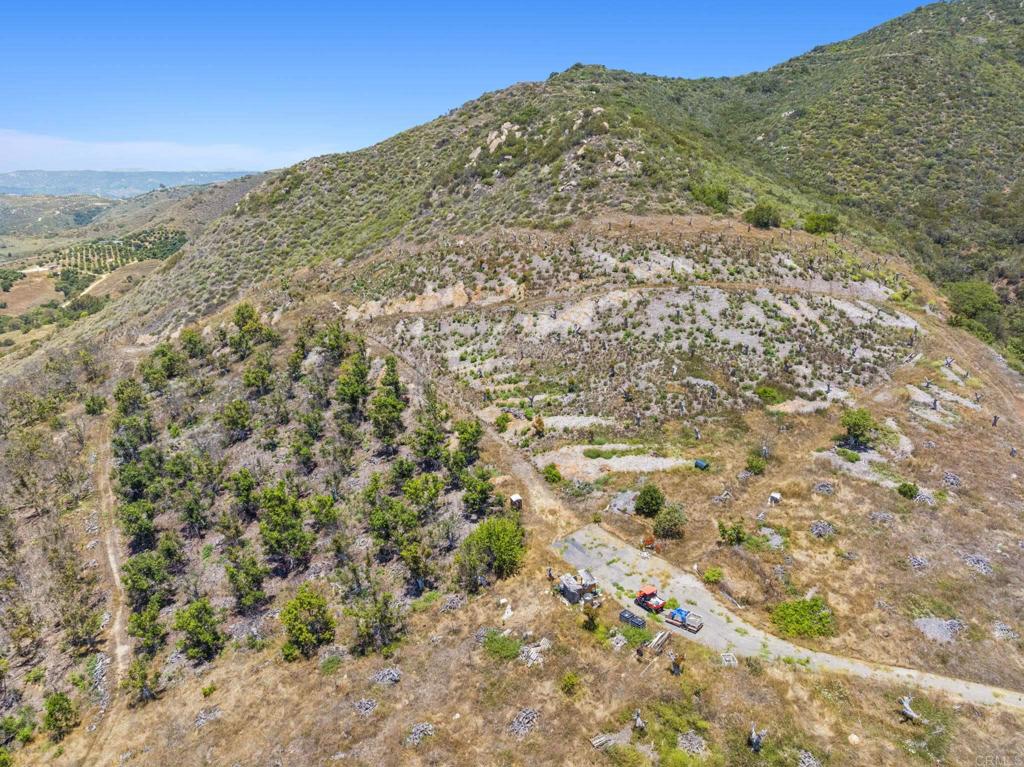Located at the end of Via Panorama in the Gavilan area of Fallbrook. Minutes to town, yet seemingly in a world of it's own. Multiple locations for opportunities to build your estate home, or create a private family compound with plenty of space and seclusion. History of the property includes a high producing avocado grove. Seller has turned off the water, and has definitely priced this parcel to sell. Includes a 3 inch water meter, and some infrastructure to potentially revitalize the existing trees. Panoramic views, existing grove roads, seasonal creek and definitely an area of future growth. Seize the moment and make this amazing opportunity yours!
