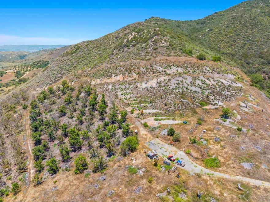 Located at the end of Via Panorama in the Gavilan area of Fallbrook. Minutes to town, yet seemingly in a world of it's own. Multiple locations for opportunities to build your estate home, or create a private family compound with plenty of space and seclusion. History of the property includes a high producing avocado grove. Seller has turned off the water, and has definitely priced this parcel to sell. Includes a 3 inch water meter, and some infrastructure to potentially revitalize the existing trees. Panoramic views, existing grove roads, seasonal creek and definitely an area of future growth. Seize the moment and make this amazing opportunity yours!