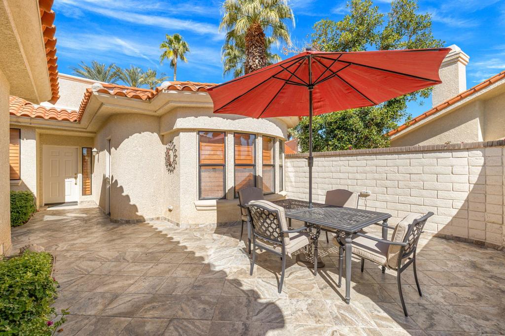 The Courtyards- the most desirable area in Desert Falls CC in the heart of Palm Desert!SINGLE LEVEL, 3 bedrooms, two full baths and one half. Gorgeous, spacious beautifully tiled Private courtyard entry greets you- Great for BBQing & entertaining! Offering much privacy. Super value in Desert Falls! Lovely cul-de-sac and wide interior streets easy for biking and taking those lovely morning or evening walks. Interior is Mostly tiled with carpeting in bedrooms. Architecturally different than most condos you've seen offering beams & vaulted ceilings! Spacious and open floor plan. Pretty wooden shutters throughout. Modern Wet bar area great for setting up your laptop!Large kitchen with breakfast room with window over sink and slider off breakfast room. Plenty of cabinets -plenty of granite counter space including a pantry. Primary suite on one side- casita style! With spa like bathroom filled with natural light -vaulted ceiling and walk-in closet. The two other bedrooms on the opposite side of property has second/guest bedroom also set up as a private suite with walk-in closet and full bathroom. Two full car garage finished inside & attached. Back patio overlooking deep grassy area, no other properties behind it - with extended patio. New living room furniture and new dining room chairs. All very comfortable - Offered Turnkey furnished! Stunning fireplace in open living room -with TV over it. Walking distance to the Fitness Center, Tennis & famous Pickle ball, as is the Clubhouse where you can dine and golf on our Championship Golf Course on a pay as you play basis! Or join one of the several memberships! May rent seasonally but not for less than 30 days. This is an opportunity to own a courtyard, patio home type of property in the Heart of Palm Desert! Close to all kinds of shopping, Entertainment, minuets from famous Acrisure Arena with top notch entertainment, Casinos, Eisenhower Medical Ctr, Rt 10, Palm Springs A/P- everything at your fingertips'! Call me for your private tour!