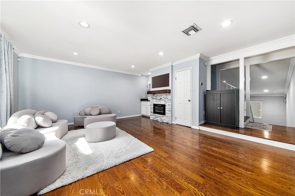 Experience the epitome of Tarzana living in this thoughtfully renovated 2-bedroom, 3-bath townhome. Step inside and be greeted by sunlit living spaces framed by soaring ceilings, gleaming hardwood floors, and a cozy, romantic fireplace beside a chic bar area perfect for entertaining. The heart of the home is a refreshed kitchen complete with a practical island, stainless steel appliances, and an intimate dining area. Retreat to not one but TWO generously sized primary suites, each boasting a fully renovated bathroom showcasing modern fixtures. One of the bathrooms features the luxury of heated tile floors for those cooler mornings. Enjoy seamless indoor-outdoor flow onto your private, lush patio—ideal for morning coffee or al fresco dinners under the stars. A convenient, updated powder room on the lower level and an in-unit laundry nook add practical touches to daily living. Smart home enthusiasts will appreciate the Ring alarm system, smart locks, Nest thermostat, and dimmable LED recessed lighting, while dual-pane windows and a newer AC unit ensure comfort, efficiency, and peace of mind year-round.
With low HOA fees that include water and trash, plus exclusive access to a sparkling pool and hot tub just steps from your door, this Tarzana gem offers comfortable, resort-style living. Complete with two side-by-side subterranean garage parking spaces with direct unit access and two generous storage units. Situated just blocks from Ventura Boulevard’s finest shops, Whole Foods, Starbucks, and a constellation of cafés and eateries, this home embodies Tarzana’s vibrant lifestyle.