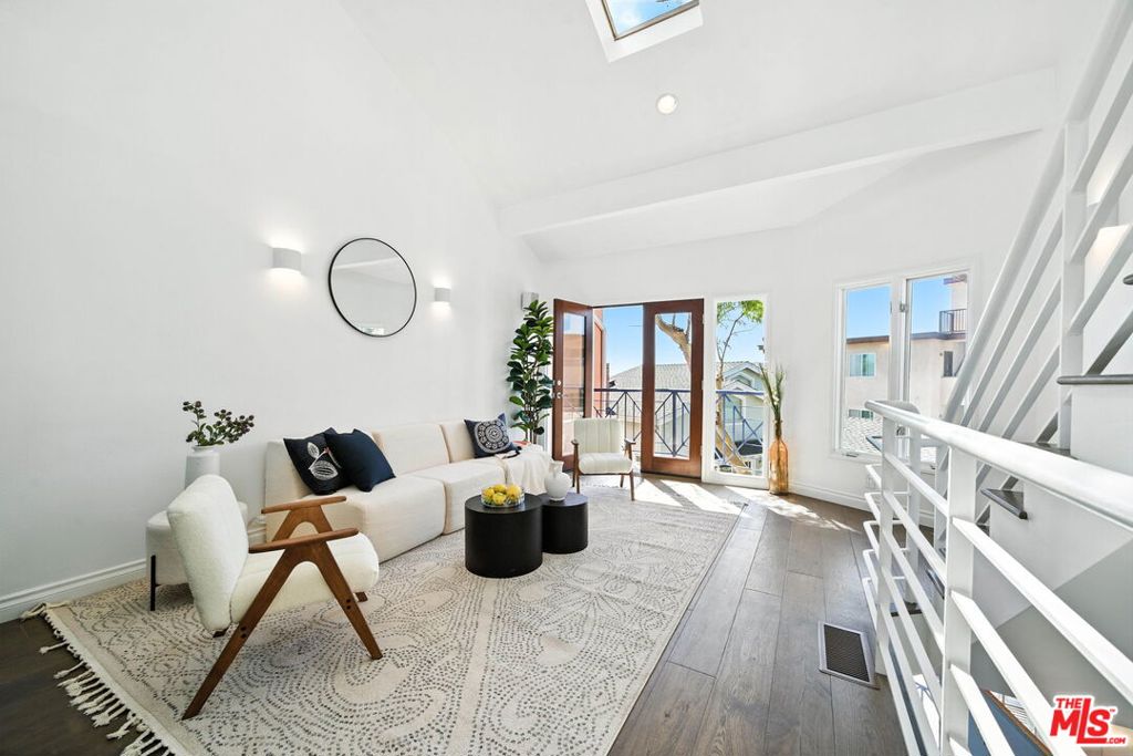 Wake up to ocean views and end your day with breathtaking sunsets in this standout two-bedroom plus loft townhome in the heart of Ocean Park, Santa Monica. Ocean views from almost every area! Just two blocks from Main Street and moments from the sand, this three-level home feels like a modern beach treehouse, bright, open, and full of soul. Remodeled with a crisp, elevated touch, the kitchen and baths were reimagined to bring function and style into perfect balance. Skylights and oversized windows invite sunlight to spill in from every angle while leafy eucalyptus branches frame sweeping views toward Malibu. The versatile third-floor loft, with its ocean backdrop, is an inspiring space for work, guests, or winding down. With four private outdoor patios, you'll catch every breeze and golden hour glow. Gated side-by-side parking, in-unit laundry, central A/C, generous storage, and a warm, friendly community add to the ease of everyday life. Plus, you're just steps from Hotchkiss Park and all the energy of Ocean Park, including cafs, boutiques, yoga, and the weekly Farmers Market. This is the kind of place that feels good the second you walk in. Don't miss your chance to live here.