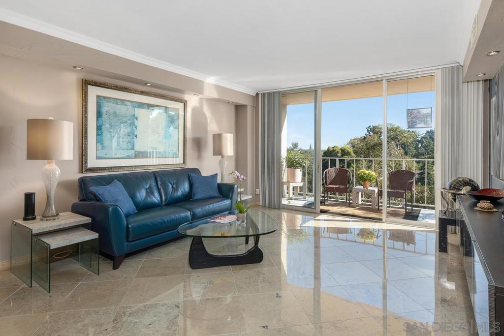 Coral Tree Plaza 6th floor, SW corner unit with a gorgeous view of treetops and the Balboa Park Tower in the distance. Stunning limestone flooring and numerous upgrades, makes this a "must-see" in this high rise condo complex at the end of 7th Avenue. One of the largest balconies at 34' feet expands your living space with an additional 200 sq. ft. for entertaining! Upgrades include recessed lighting, upgraded showers, large walk-in closets in both bedrooms, remodeled kitchen, glass block wall in primary bathroom, and a Neptune washer/dryer. Urban living at its finest, just a short walk to Whole Foods, dining, Uptown District, Balboa Park and nightlife located in the very heart of Hillcrest. It is hard to believe that this quiet condo, with such a gorgeous view, is located so close to everything. This condo has 2 dedicated parking spaces and a storage locker. Also in the underground parking area is a bike storage area and car wash. Amenities include tennis/pickle ball court, guest suites, fitness center and clubhouse that has a kitchen, fireplace & pool table. Heated pool & hot tub are close to the clubhouse.