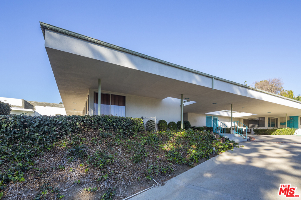 Sited up a private drive, in an unparalleled Beverly Hills location north of Sunset Blvd. sits this unique Mid-Century home and an opportunity to re-imagine it. The single-story residence incorporates features that allow for an ease of entertaining and living. The double door entry leads to a sky-lit foyer with two atria separated by the dining room. A family room with a wood-paneled bar and fireplace allows a cozy setting that leads to the pool. Available for purchase with adjacent property 1030 Woodland Ave (APN #4350-012-021) which is sited on a 23,268 lot.
