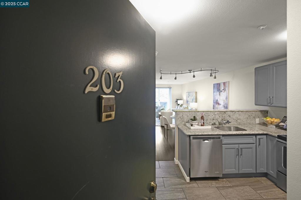 Welcome to 2901 MacArthur Blvd, Unit 203. This 2 bedroom, 1 bathroom unit has an updated kitchen with sleek grey cabinets, solid countertops, and stainless steel appliances. Making it a stylish yet functional space. The tile entryway adds a touch of elegance as you enter, while the freshly painted walls and dark floors flow seamlessly throughout the home. Kitchen overlooks the living room and dining space, great for entertainment and connecting with guests. The large slider brings in natural light and access to the balcony. The bathroom features tile work with beautiful accents. With one designated parking spot, convenience is key! The location on MacArthur Blvd offers easy access to major transit routes, local shops, and a wide range of dining options. Situated just moments from downtown Oakland and the vibrant Fruitvale district, you'll have the best of city living at your doorstep.
