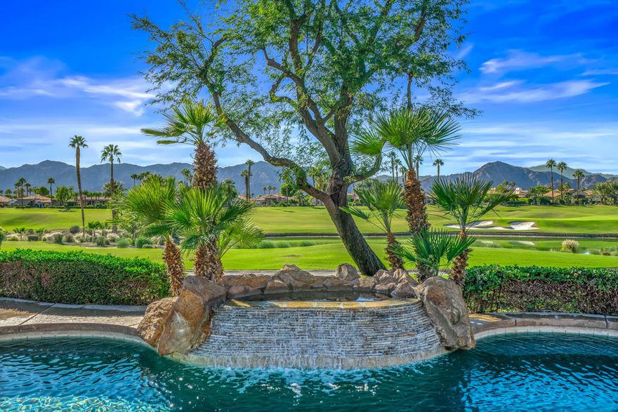 Situated on a premier lot near two fairways, also with lake and mountain vistas, this Encanto One residence captures the scenery and relaxed sophistication of Rancho La Quinta Country Club. High ceilings, abundant natural light, and quality construction define the open layout connecting the living room and fireplace to a generous kitchen finished with granite surfaces, island seating, and stainless-steel appliances. Designed for effortless entertaining, the backyard offers a pool with two waterfalls, raised spa, built-in barbecue station, and multiple seating areas covered and uncovered, surrounded by new desert landscaping and turf. Three bedrooms plus a den provide needed privacy; each bedroom is ensuite, including a spacious primary suite with a large walk-in closet and well-appointed bath. Additional features include a two-car garage with separate golf-cart bay and refined architectural detailing throughout. Homeownership includes guard-gated security and Athletic and Social memberships granting access to the Racquet Club's tennis, pickleball, bocce, fitness, and dining facilities, along with two eighteen-hole golf courses designed by Robert Trent Jones and Jerry Pate, respectively. The home sits off the 4th hole of the Pate course, and the 7th hole is across the lake. Furnishings are negotiable.