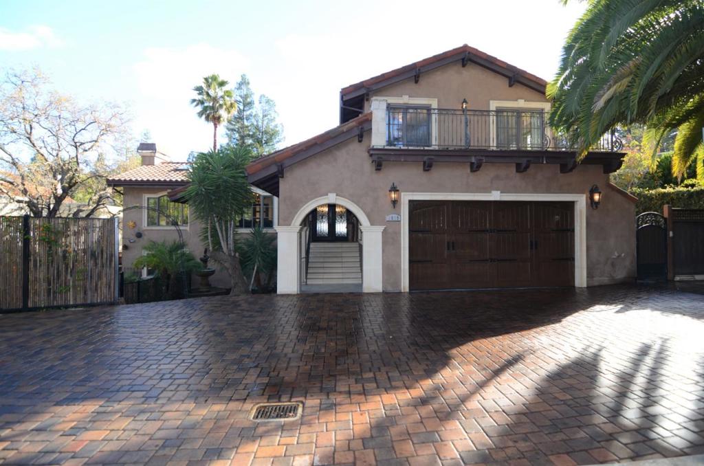 Beautiful Mediterranean "Italian Villa" with custom stone paved driveway. Grand foyer with circular staircase and travertine stone floors. Spacious formal dining room. Spectacular chef's kitchen with dramatic rosewood cabinets, Carrera marble counters, high-end stainless appliances, and old wood hardwood floors. Massive family/living room with vaulted beamed ceilings, skylights, fireplace, and sliding glass door to travertine stone balcony with over-head heaters. 2 master suites. 3 separate travertine balconies. Awesome Infinity edge solar pool w/spa and waterfalls. Expansive outdoor entertaining area with full BBQ kitchen.