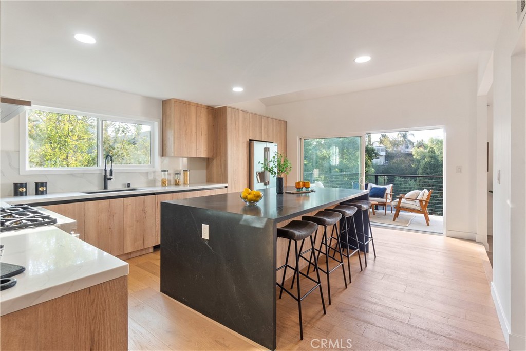 Perched in the coveted South of Ventura Blvd neighborhood of Woodland Hills, this stunningly remodeled property offers a total of 3,500 square feet of luxurious living space, including a beautifully designed 2,740-square-foot main residence and a fully upgraded 800-square-foot ADU—perfect for guests, rental income, or multi-generational living. Elevated in the hills, the property boasts panoramic city light views that serve as a breathtaking backdrop to this elegant retreat.
The main residence features three spacious bedrooms and three beautifully designed bathrooms. At the heart of the home is a chef’s dream kitchen, outfitted with brand-new Signature appliances, custom oak cabinetry, Bedrosians Calcatta Milan quartz countertops, and a striking Brussels Blue quartz island.
The primary suite is a sanctuary of comfort, complete with a custom walk-in closet, a built-in sauna, and a spa-inspired bathroom showcasing Venetian plaster shower walls, limewashed finishes, and brushed bronze hardware. Throughout the home, thoughtful upgrades include smooth stucco walls, recessed lighting, Pottery Barn and Arhaus light fixtures, and Arcadia European oak flooring. Expansive new Mangaris decks with steel cable railings extend the living space outdoors, offering the perfect vantage point to enjoy the serene surroundings.
The ADU mirrors the quality and craftsmanship of the main home, featuring a modern kitchen with Samsung appliances, white shaker cabinets, Calacatta Caramel quartz countertops, and elegant finishes. Additional highlights include recessed lighting, central AC and heating, and matching oak flooring, ensuring a seamless integration of style and comfort.
Located just moments from the 101 Freeway, Whole Foods, Trader Joe’s, and the area’s finest dining and shopping, this home offers a rare combination of privacy, convenience, and elevated living in the hills of Woodland Hills.
