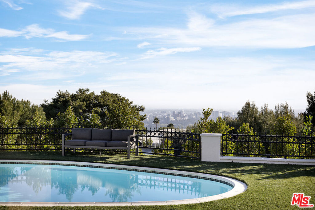 $200,000 reduction!!! 600 Clinton Place is located with city views in the prestigious Trousdale/Loma Vista enclave of Beverly Hills. With five bedrooms and eight bathrooms in 6,217 square feet of living space, this property presents an exceptional opportunity to move in as-is or upgrade to a luxurious estate. The grand foyer opens to a large space containing a formal living room and family room, divided by a two sided fireplace. There is a built-in entertainer's bar, and sliding glass doors seamlessly connect the interior to the pool, outdoor dining area and views. Additional home features include a formal dining room, spacious bedrooms, bonus rooms, elegant baths, oversized garage and much more. Moments away from the best of Beverly Hills, 600 Clinton Place embodies the epitome of exclusive Southern California living with a backdrop of stunning vistas. Shown by appointment only.