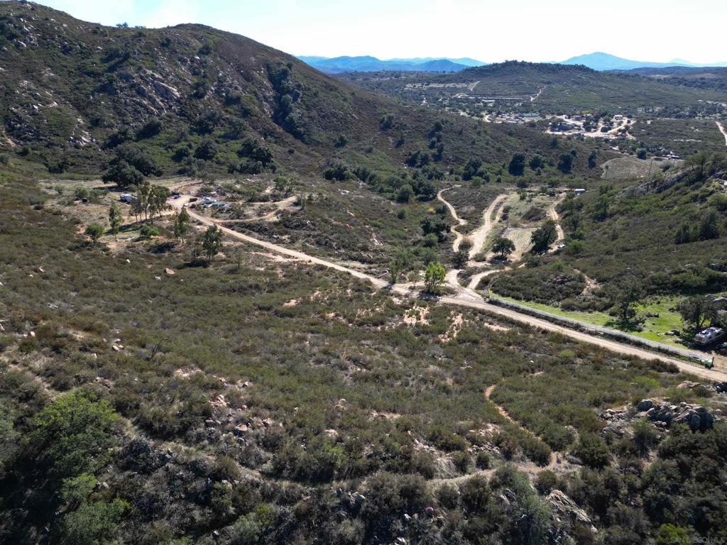 One of the best locations in Ramona with desired Animal Designator "O" Zoned A72. Rural Residential Paradise! Looking for a 360-Degree view? This is it! Overlooking former Golden Eagle Farm, including views to the West towards Mt Woodson and East Enjoy phenomenal sunrises and sunsets from this 9+ acre lot. Easy to drive dirt road opens onto a peaceful valley perfect for animals, farming, and more. Close to local vineyards, camel farm, ranches and more. Enjoy panoramic views from the potential ridgeline pad, over 1300 FT of ridgetop land! Several boulder/rock outcroppings, majestic oak trees and more. This is an area with wells and septic. There is a drilled/capped well on the property. Well was drilled 2004, no power and/or equipment. Water test avail. from 2022. Several usable acres. O Designator allows for horses, livestock, dog kennels, vineyard, endless possibilities. Estimated 3-4 usable acres. Property is all on the West side of the dirt road. Well is located very close to the road.