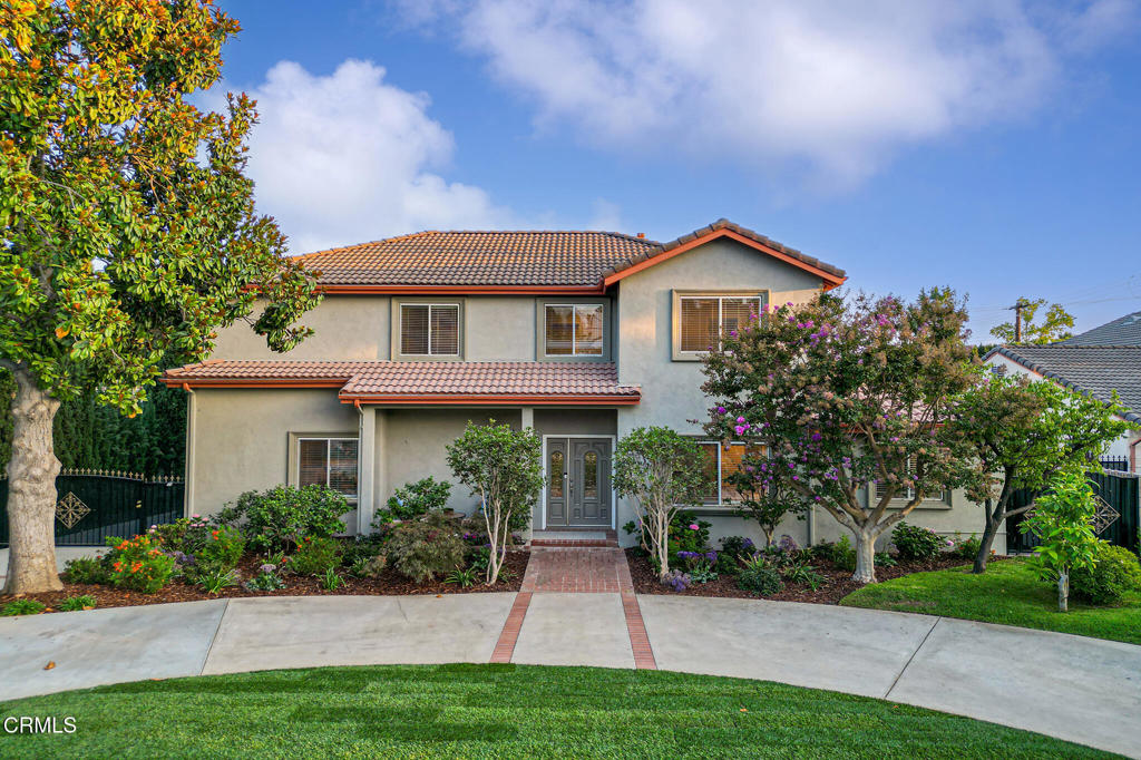 Situated in the sought-after San Pasqual neighborhood of Pasadena, this completely reimagined estate was built in 1951, expanded in 2000 with a full second story, and masterfully renovated over the past year to offer the perfect balance of modern comfort and timeless appeal. A lush lawn, vibrant blooms, and a sweeping circular driveway lead to an inviting covered porch, providing a gracious introduction to this exceptional home. The flowing floor plan begins with the bright entry & living room, complemented by a versatile den/office & stylish powder room. A downstairs suite provides comfort for guests or multigenerational living, featuring a brand-new ensuite bath, walk-in closet, & a picturesque window with serene garden views. The expansive family room, defined by a custom wood-slat divider, features sliding doors that open to the backyard patio for seamless indoor-outdoor living. The formal dining area, highlighted by an elegant chandelier, is complemented by a built-in serving counter, with the tasting lounge tucked gracefully behind. Outfitted with dual wine refrigerators and custom cabinetry, this sophisticated space creates a refined setting for entertaining. The chef's kitchen is the hub of the home, anchored by a large center island with a striking Azul Calacata quartz countertop that doubles as a breakfast bar. Custom cabinetry provides abundant storage, while professional-grade Thermador appliances create a space crafted for both culinary artistry & everyday living. An adjoining laundry & utility closet add convenience & direct access to the raised back patio, an ideal setting for dining al fresco. The second story offers three well-appointed junior suites, each with its own en suite bath and generous closet space. The luxurious primary suite features a spa-inspired bath with custom cabinetry & makeup vanity, dual walk-in closets, and an intimate sitting area overlooking the backyard, offering ultimate privacy. The backyard, inspired by a Chinese garden, showcases a stunning pavilion, cascading waterfall, tranquil pond, flowering trees, & a lush lawn with fruit trees. Multiple gathering areas create idyllic spaces for relaxation and entertaining--true California living! A gated driveway leads to a detached garage with a permitted 270 sqft bonus room offering endless possibilities. Designed for both daily living and sophisticated gatherings, this exceptional estate offers an unmatched lifestyle of elegance, comfort, & resort-style relaxation!