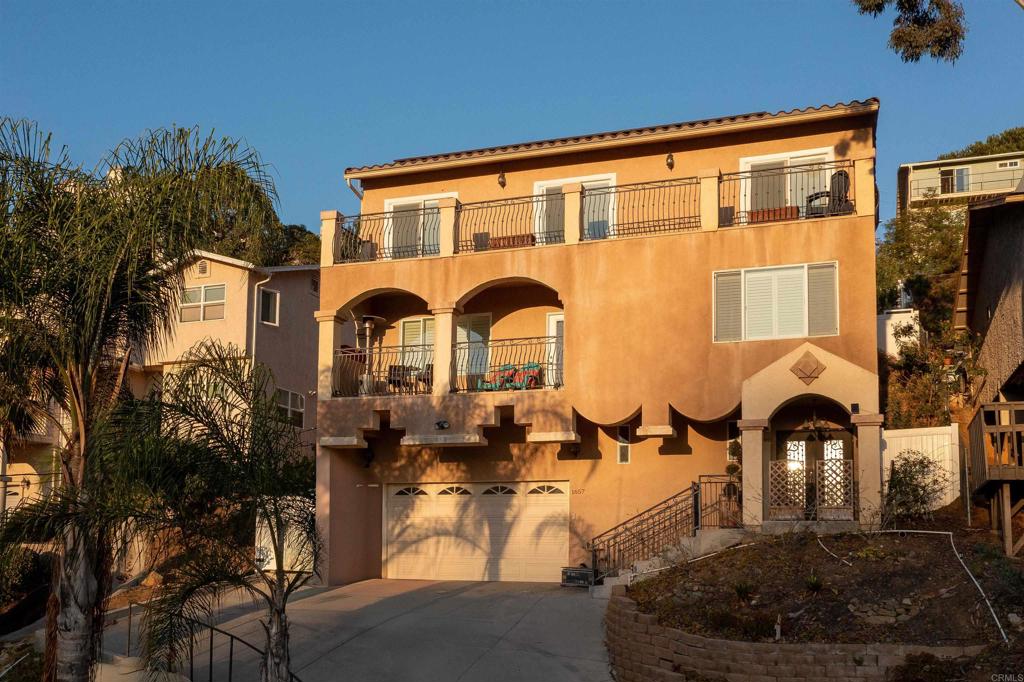 Enjoy sweeping south- and west-facing vistas from this thoughtfully designed residence, nestled in a scenic setting. The open-concept layout features a spacious kitchen with ample cabinetry and countertop space, seamlessly connecting to a generous dining area and inviting living room—perfect for both daily living and entertaining. Interior highlights include soaring ceilings, expansive balconies, an elegant iron-and-glass entry door, and decorative wrought-iron railings. A versatile bonus room offers the flexibility to serve as a home office, gym, or playroom. Step outside to a tranquil backyard with a designated patio area ideal for outdoor dining, plus additional space for gardening or quiet relaxation. With timeless design elements and functional living areas, this home offers an exceptional lifestyle in a stunning natural environment.