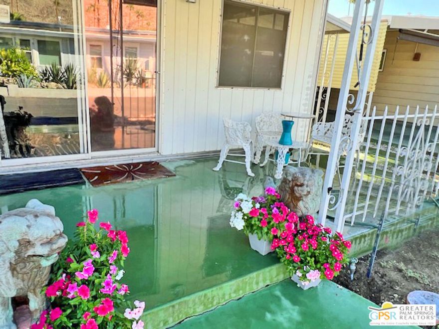 In Sahara Park, a senior community under rent control, this 1967 Goldenwest double wide coach has two bedrooms, two bathrooms remodeled in tile, open living room to dining area/office, and vintage kitchen.  Laminate flooring installed in 2023. Ceiling fan with light and disappearing blades when not in use, central air and heat, stacking washer and dryer, refrigerator, oven, range and breakfast bar in the kitchen. Front and back covered patios the whole length of the unit with stunning Mountain Views from the front patio. Park amenities: Pool, spa, clubhouse with card room, TV room, library, full kitchen, stage, meeting room, and electronic bingo board. There is a newly renovated exercise room and many park activities.