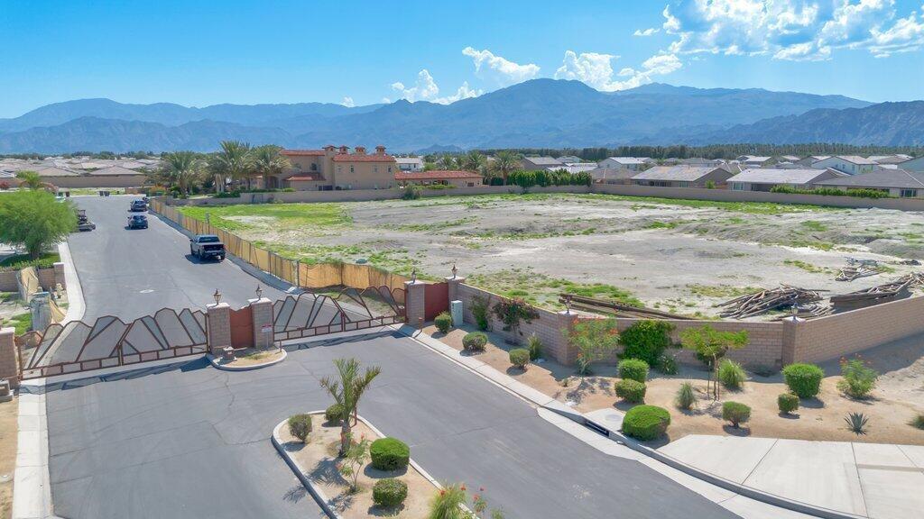 Seize the opportunity to own a prime piece of real estate just moments from the world renowned Coachella Festival. This expansive lot, over 35,000 square feet, is situated in a prestigious gated community with a beautifully landscaped entrance. It offers a perfect setting to build your dream home, create a lucrative investment property, or craft the ultimate vacation retreat. With utilities available at the street and a lot ready for construction, this is an exceptional opportunity you don't want to miss.