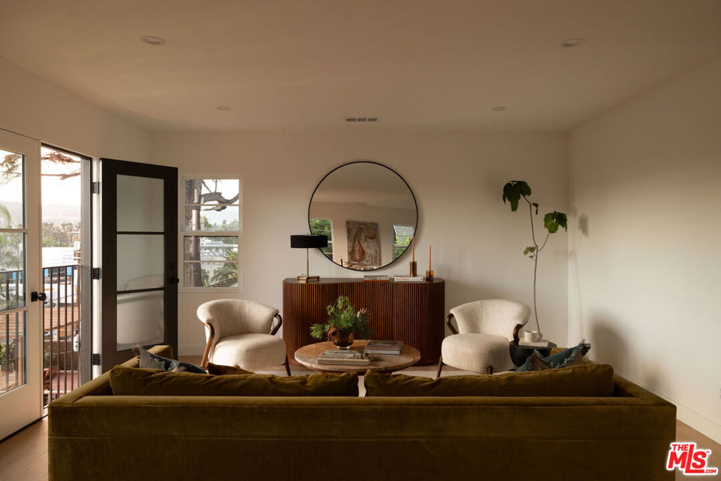 Set on a promontory with sweeping views that survey the city, hillsides and landmarks like the Hollywood Sign and Griffith Observatory, a meticulously renovated creative compound in prime Silver Lake by AIH Development. Perfectly situated for multigenerational families, 'house hackers' looking to get into homeownership and offset their mortgage with rental income, or those looking for property that provide ample space for creative living. The property consists of a front dwelling, configured as an upper and lower unit, and a separate guest casita. Newly rebuilt in 2025, this special home offers premium design finishes and materials, considered kitchens with high end appliances and ample bedrooms with built in closeting and large en suite baths. The front structure offers two separate living spaces, each with their own entrance. Each floor plan features 2 bedrooms, 2 bathrooms, living room, dining area, and kitchens. Facing toward the southwest, with romantic French door Juliette balconies, enjoy exceptional natural lighting all day long and stunning sunsets, framed by panoramic views of the city. Luxurious amenities include designer tile and stone bathrooms, oak engineered flooring, kitchens with custom white oak cabinetry, eat-in peninsulas and Fisher Paykel and LG appliances. The separate guest casita is perfectly proportioned with a private grassy side yard. From stucco to windows, doors, roof, water lines, sewer, electrical, and HVAC, this property has been meticulously rebuilt with energy efficiency, longevity, and ease of maintenance in mind. No expense was spared on the exterior and grounds with a significant landscaping program, automatic sprinklers, and photocell pathway and landscape lighting. Fully gated for security and privacy, the bricked pedestrian entrance features Door Bird intercom system and the expanded driveway has an automatic gate for ease. Two private garages and one dedicated parking space each feature their own 240v charging portals. Situated in Silver Lake's Sunset Junction, the location is unmatched with the best amenities in the neighborhood literal steps from your front door - Erewhon, Silver Lake Pool & Inn, Intelligentsia, Bar Seco, Santo, Tartine, Stella, weekly Farmer's Market, Condor, Bacari, and so much more. Rarely do opportunities to own a significantly upgraded and thoughtfully designed, creative property in an A+ neighborhood become available.