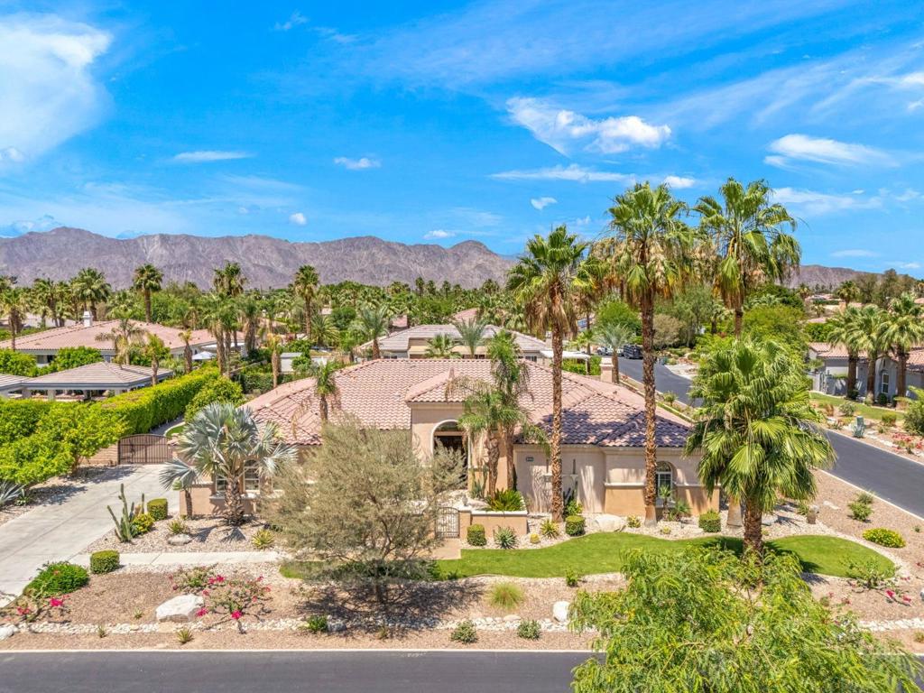 Desert Dream Oasis Resort Living at Home! Welcome to your turnkey desert retreat where luxury, comfort, and entertainment come together on a beautifully landscaped half-acre lot. This upgraded home blends open-concept living with soaring ceilings, natural light, new tile and wood flooring throughout. The chef's kitchen is a showstopper, featuring high-end appliances, sleek countertops, and ample storage perfect for hosting or everyday living. Step outside to your private backyard resort, complete with a sparkling pool, spa, waterslide, outdoor kitchen, putting green, bocce court, and multiple areas to relax. The expansive primary suite is a serene escape with a spa-inspired bath, soaking tub, and a walk-in closet the size of a bedroom. Located in the sought-after gated community of Desert River Estates, this home offers a peaceful seclusion with easy access to shopping, dining, and recreation. Live everyday like you're on vacation! Schedule a private tour today. Don't Miss this one! Bonus - ALL Furnishings included!