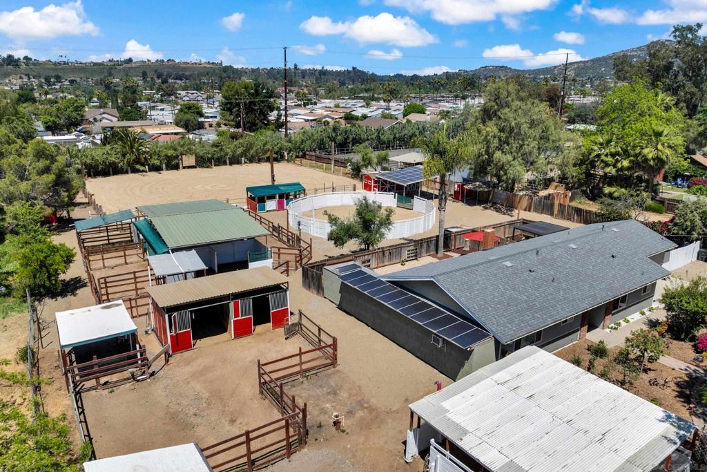All usable 1.31 flat acres in central Poway with an arena, mare motel, round pen, two stall barn with oh, so much more! Enjoy the open floor plan with great upgrades to the primary residence. A shared laundry room connects a 500 sq ft studio, bathroom and kitchenette with appliances...both having private backyards! Semi-circle driveway allows for ample parking, a new roof, paid solar & RV parking w/hookups & extra RV storage area! Room for many animals and family fun!! Close proximity to Old Poway Park, weekly Farmers Market, Elementary school & local retail and restaurants!