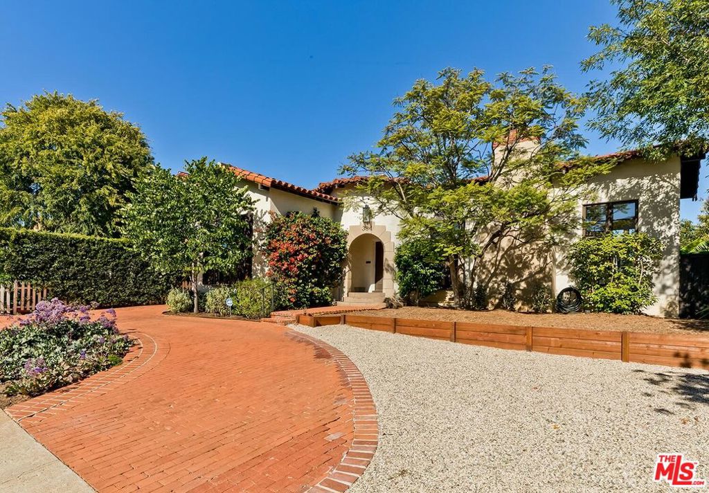 Discover this beautiful 1930s Spanish-style home on a spacious flat lot in prime Brentwood. This single-story gem offers a perfect blend of classic charm and modern updates. The elegant living room, with its vaulted beamed ceiling and original windows, is ideal for entertaining. The oversized dining room connects seamlessly to a contemporary kitchen with stainless steel appliances and ample storage. The primary suite is a private retreat, featuring an en-suite bath, walk-in closet, and direct access to a tranquil backyard deck. Two additional bedrooms, each with their own bathrooms, provide comfort and privacy. The family room opens to a sunlit deck and a sparkling pool and spa with stunning canyon views. Additional amenities include a laundry room, horeshoe driveway, two-car garage, and an EV charger. Ideally located near Sunset Blvd and Brentwood's best offerings, this home is a rare find. Don't miss the chance to make it yours!