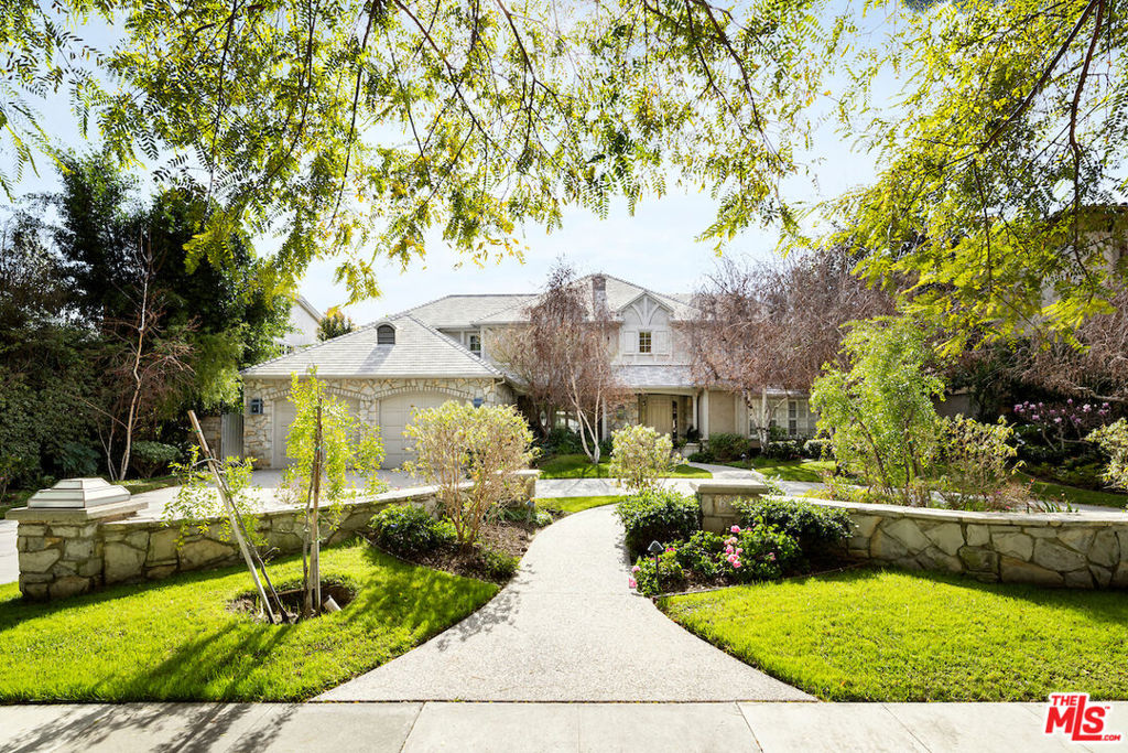Welcome to this breathtaking traditional estate in the heart of the coveted Beverly Hills flats neighborhood! Impeccably maintained inside & out, this move-in-ready residence features a stunning circular driveway, a two-car garage, and mature landscaping. As you enter the grand foyer with hardwood floors, a chandelier, and a sweeping staircase, you'll be drawn to the exquisite formal living room with a marble fireplace & multiple areas for lounging or entertaining. The formal dining room connects seamlessly to the butler's pantry, breakfast nook, and chef's kitchen, with built-in cabinets throughout for plenty of storage. Upstairs offers three bedrooms, all en suite, plus an office/den which connects to the primary suite. Step outside into your private paradise featuring a spacious covered patio, outdoor heater & pool/spa with fire feature perfect for hosting friends and family year-round. This fantastic home is ready for you to call your own - take advantage of this opportunity to live in the flats now!