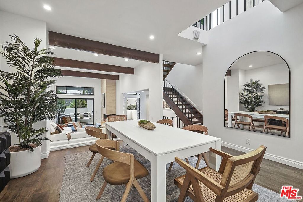 Beautifully upgraded end-unit townhome, tucked away in the exclusive Michael Lane Villas of Palisades Highlands. With only one shared wall, this residence offers rare privacy alongside timeless elegance. Soaring vaulted ceilings, skylights, and walls of windows that flood the interiors with natural light. The open living areas showcase gleaming hardwood floors and an impressive floor-to-ceiling fireplace, while panoramic mountain vistas create a stunning backdrop. A private patio extends from the living room, perfect for al fresco dining, and the primary suite enjoys its own balcony retreat. The chef's kitchen is a showpiece, featuring high-end appliances, lacquered cabinetry, marble countertops and backsplash, a spacious center island, dual ovens, wet bar, and custom finishes designed for both beauty and functionality. Two spacious bedrooms each offer ensuite bathrooms, with the primary suite enhanced by a cozy fireplace and spa-inspired bath. Additional highlights include a remodeled secondary bath, attached two-car garage, and in-unit laundry. Just steps away from the community pool and fitness center, this sophisticated residence combines luxury living with comfort and convenience - a rare opportunity in the Highlands.