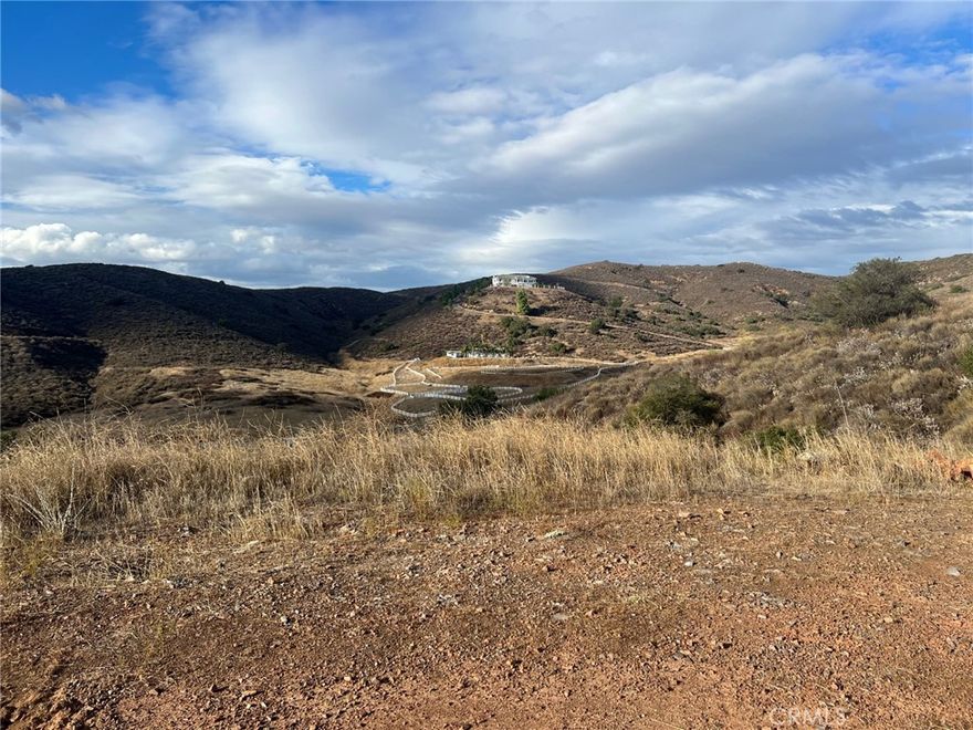 Come discover this  Santa  Rosa West   (10  Acre minimum area)  on the Santa  Rosa  Plateau.  There are extrodinary  views  from this turn around  area where one  will evetually build   a ranch- estate  home..   Park on  Calle   Rosita  and  hike  up the  Via  Feliz private  culdesac. Take in the  tranquil ambience  of Santa Rosa  West and   notice  the gentle terrain.    This 10  Acre  gross parcel offers the rare  combination of  panoramic views  andsome  usable property  (perfect  for planting olives  or  grapes  or  raising some  horses).   Easy access from Interstate  15  less than  10 minutues  to town amenities of shopping  and  schools.   Excellent opportunity to escape  the City life  and enjoy thequiet country  surroundings!