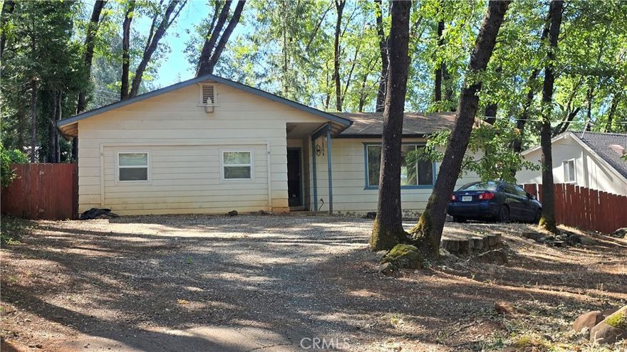 3-BED, 2-BATH AND 2 BONUS ROOMS!  Originally a 1274 sq.ft., home, the 480 sq.ft. garage has been converted to expand the living space with a large laundry room (including a nook for an extra fridge/freezer), a walk-in pantry, and 2 BONUS ROOMS with closets—perfect for additional bedrooms, a home office, or hobby space.  The lot is beautifully treed and thoughtfully designed with a fully fenced and cross-fenced backyard, ideal for separating pet and people spaces. Enjoy outdoor living on the charming paver brick patio with stone curbs and retaining walls. There is plenty of parking in the driveway, including room for RV parking and front yard space, plus a side-gated backyard access.  Inside, the master suite features a spacious closet, dressing area, and private walk-in shower. The guest bath offers a full tub/shower combination and has been freshly updated with a new ceiling fan/vent, sink faucets, and shower rod. You’ll find five separate rooms to use as bedrooms, offices, or bonus areas—ideal for large households or those who need versatile living options. There is a tile entry, updated lighting and plumbing fixtures in many locations, ceiling fans with lights throughout and an energy-efficient tankless water heater.  The home includes amenities from an HOA with a low fee of just $310/year that include a swimming pool & hot tub, pickleball courts, basketball court and bocce ball, clubhouse with full kitchen, plus a bar & lounge area, lots of social activities, hiking trails and so much more! Located in a quiet yet well-connected part of Magalia, this home offers easy access to local schools and amenities while providing the peaceful backdrop of mountain living. This home is a cosmetic fixer and ready for your finishing touches—fresh paint and new flooring will make it shine again. Take advantage of the discounted price and create a space that’s truly your own! Set on a generous quarter-acre lot, this property offers space and tranquility. Enjoy sweeping mountain views that bring the outdoors into every season. Spacious 1,764 sq.ft. home offering flexibility and room to grow!