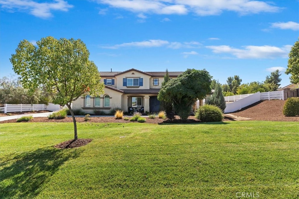Welcome to Calder Ranch, where elegance meets endless possibility! Nestled in one of the area’s most sought-after communities, this impressive two-story residence offers the perfect blend of privacy, comfort, and space. Sitting at 3,867 sq.ft. of living space, on a 43,626 sq.ft. lot, this home is designed for both grand entertaining and everyday living. As you arrive, the stunning curb appeal and thoughtfully designed landscaping welcome you in. The massive driveway features endless room for RV parking and any and all of your toys. Plus it still boasts a 3 car garage, ensuring ample space for all your needs. Step onto the charming front porch and picture yourself enjoying warm cups of coffee. Inside, soaring ceilings and abundant natural light set the stage for that wow effect. Regal formal living and dining room with chandelier that elevates the home’s sophisticated style. A convenient downstairs office/den and full bath, offers flexibility for work or leisure. The chef’s kitchen is a dream with rich cabinetry, granite countertops, a 5-burner gas cooktop, double ovens, a massive pantry, and a spacious center island which seamlessly opens to the cozy family room with gas fireplace. Just beyond, a huge laundry/mud room with utility sink, and backyard access makes multitasking effortless. Upstairs features a generous loft, perfect for movie or game nights. The expansive primary suite is a true retreat, featuring a lounge area, spa-like bath with soaking tub, walk-in shower, dual vanities, and an enormous walk-in closet. The additional bedrooms are equally spacious, which share a another full bath with dual vanities. This backyard is a blank canvas limited only by your imagination. Whether you dream of adding a pool, sports court, guest house, need work space or simply creating the ultimate garden sanctuary, there is ample room for every vision and every toy. This home offers the perfect blend of peaceful, country-inspired living with the convenience of being just minutes from shopping, freeways, schools, and businesses. This is truly a must-see property where the potential is limitless and the lifestyle extraordinary.