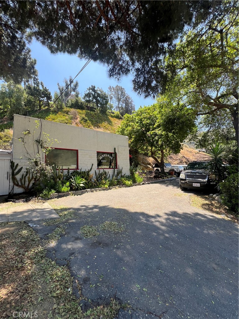 Excellent visibility with over 200 feet of frontage along Laguna Canyon Road. Large space that is currently leased to Jeeps R Us. Lease expires 7/1/28. Tenant pays utilities and property taxes. Property is zoned for M-1A Light Industrial. Perfect for car repairs and sales. Seller is also real estate broker.
