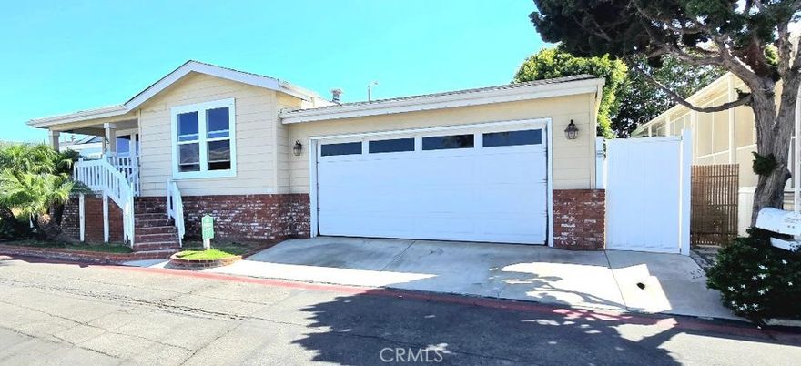 Only 1 1/2 blocks from the OCEAN with a 2-car garage!!! 3 bedrooms and 2 baths. This Awesome house is in the lovely, “Huntington Shorecliffs” Community… Look no more! Walk to the beach in 5 minutes!!!  Gorgeous open floor plan, with giant living and dining room. This beautiful home is 1,608 sq ft and is light and bright. Included with home: Stainless steel refrigerator, washer and dryer, brand new dishwasher, and stove. 1 year home warranty also included!!! Also included upgrades: Kitchen-Aid Chef package, Mohawk distressed wood flooring, throughout Home, Quartz Counter tops, Copper/Glass backsplash, Tile in Kitchen, Double Convection Oven, Microwave, Built-in wine, bottle refrigerator, Master Bedroom has built in cabinetry in closet, Stand up shower with bench, jetted Jacuzzi Tub, Marble and glass in lay, Marble floor in shower, Porcelain floor and walls, Custom Wood Cabinets, 2nd bathroom, Shower overhead sprayer, Stone and glass glamour, shower door, Backyard Jacuzzi, garage has epoxy flooring.  Central Heating and a giant private back yard. The monthly park lease is Approx. $3,200 a month, which includes access to the community clubhouse, and pools. All located in the park’s private community down the street from the Pacific Ocean and down the street from the famous Huntington Beach Pier and "Pacific City" with new shops and restaurants.