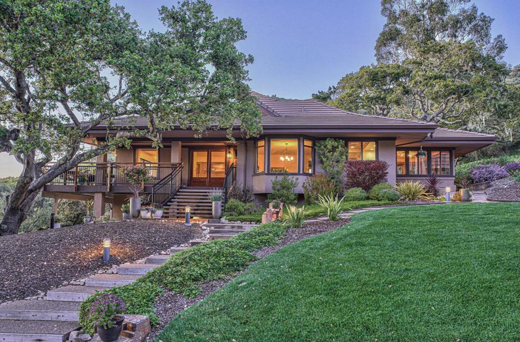 Artfully designed by its original owners & since loved and appreciated by the current owners, this serenely private home & separate studio guest house offer captivating views of the beautiful natural surroundings. Marvel over the exceptional sunsets nightly while cozied up to the wood burning f/p in the spacious LR. Whether its a quiet dinner for two or, a holiday dinner for a crowd the dining room can easily accommodate. Youll love the light-filled kitchen with granite counters, lots of storage & walk-in pantry. The primary suite provides two large walk-in closets and, access to the wrap around deck w/ an inviting hot tub where you can soak your cares of the day away. Completing the main floor is another bdrm, laundry room, main bathroom & a sunroom--the perfect spot for relaxing with a morning cup of tea or evening cocktail. On the ground level youll find another primary suite w/ its own f/p and separate entrance. A pathway from the main house leads to the studio guest house located above the detached garage/workshop. From the soaring ceiling & expansive west facing windows, to its loft sleeping/office area and, industrial, New York apartment vibe this space will knock your socks off! Exuding a warm welcoming elegance this truly is a special not-to-be-missed property!