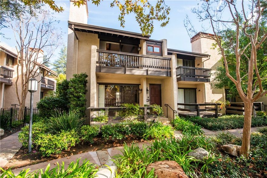 Welcome to this beautifully situated 3-bedroom, 3-bath end-unit townhome, surrounded by lush greenery, mature trees, and a tranquil creek. Offering over 1,980 square feet of living space, this home is a true entertainer’s dream with an open-concept layout, recessed lighting, crown molding, beamed and cathedral ceilings, in-ceiling home theater speakers, and four private patios.

The home features two Ring doorbells and a security system for added peace of mind. The upgraded kitchen provides ample cabinetry and is equipped with a stainless steel refrigerator, stove, dishwasher, and microwave. The desirable Plan D layout includes a sought-after atrium alcove on the main floor, bringing in natural light and architectural charm.

Upstairs, the open and bright primary suite showcases cathedral ceilings with exposed beams, two closets—including a walk-in closet connected to the ensuite—and a private patio with serene views of the creek and pool. Two additional spacious bedrooms and a full bathroom complete the second level.

The lower level offers a versatile bonus room, ideal for a home office, movie theater, gym, or additional living space, along with a newer washer and dryer. An attached two-car garage includes abundant built-in storage and a 220V outlet for EV charging.

The HOA covers internet, water, basic cable, and earthquake insurance. Residents of Warner Village 1 & 2 enjoy an abundance of amenities, including walking paths, creeks, ponds, tennis courts, pools, spas, and recreation rooms. Ideally located just minutes from shopping, dining, and entertainment, this home offers comfort, convenience, and a resort-style lifestyle.